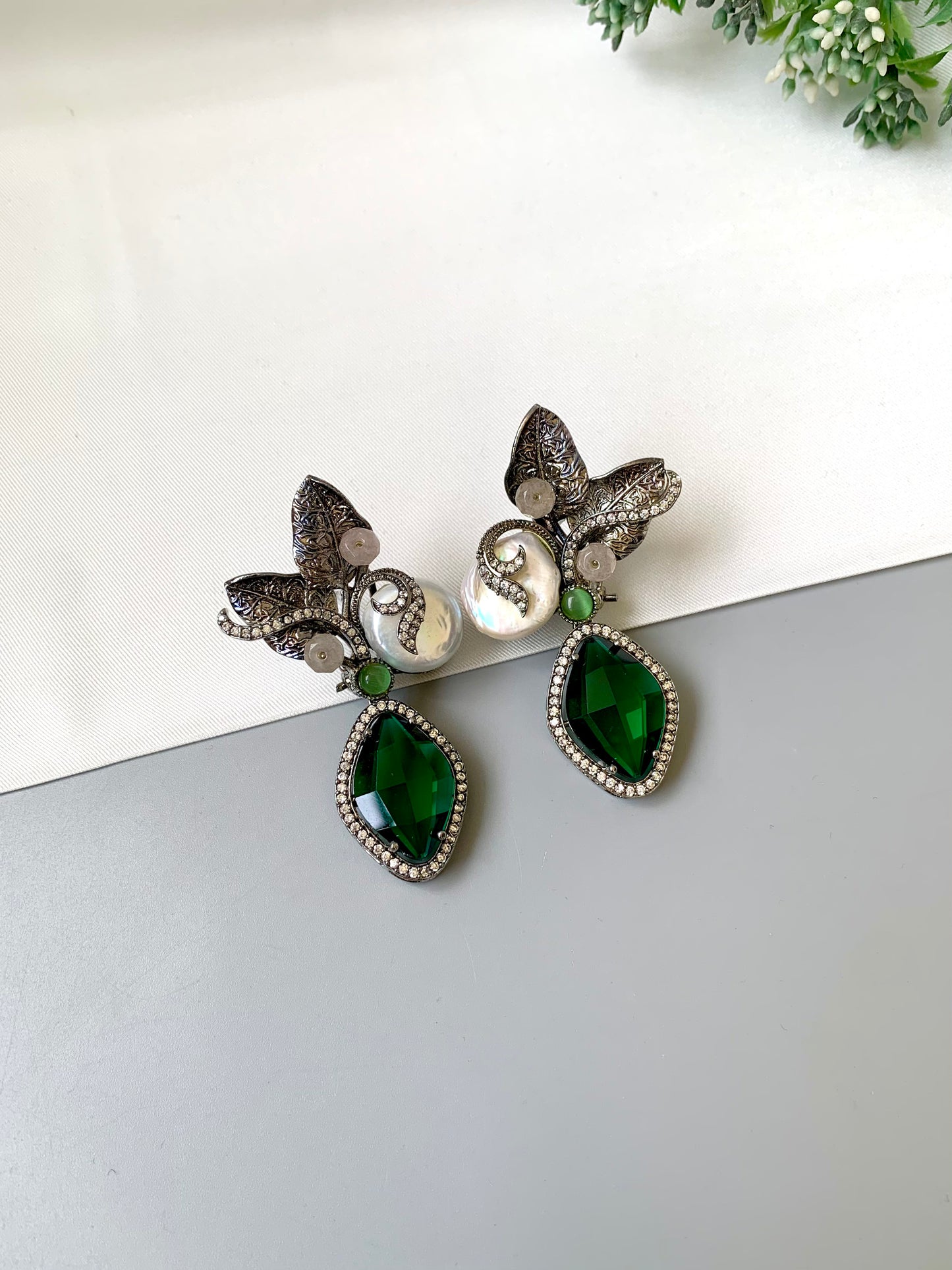 Krisha designer earrings in rhodium finish with baroque pearls, emerald and onyx gemstones