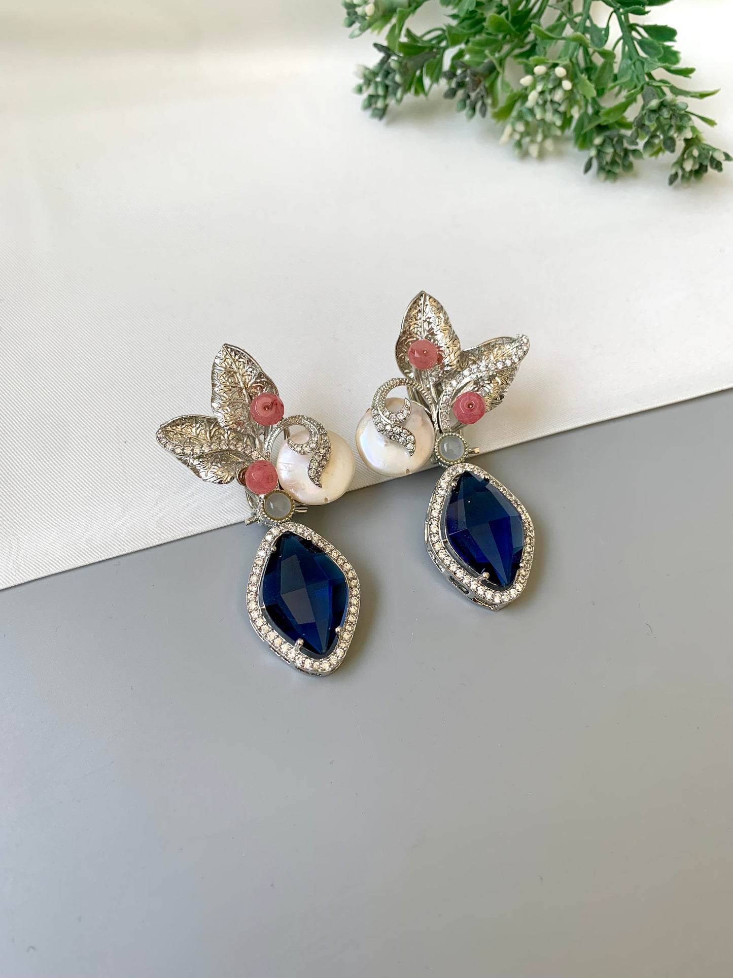 Krisha designer earrings in rhodium foil finish with baroque pearls, sapphire and onyx gemstones