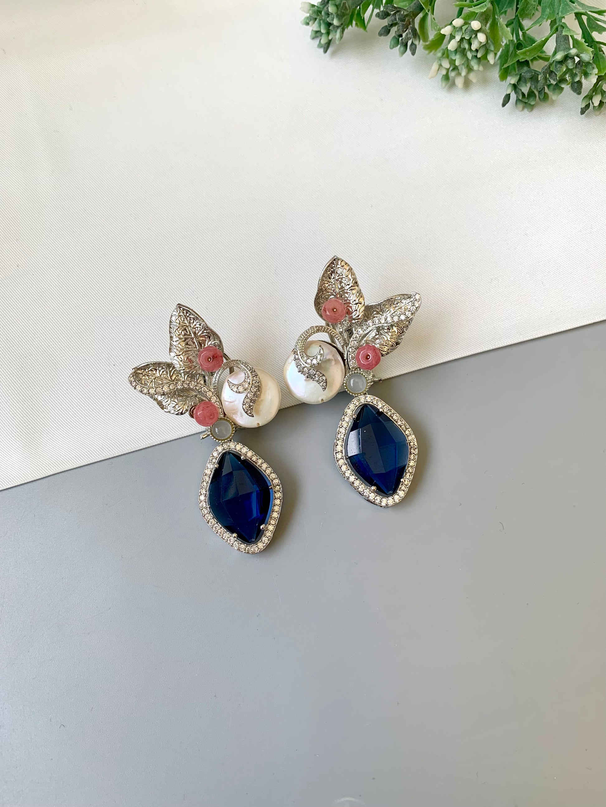 Krisha designer earrings in rhodium foil finish with baroque pearls, sapphire and onyx gemstones