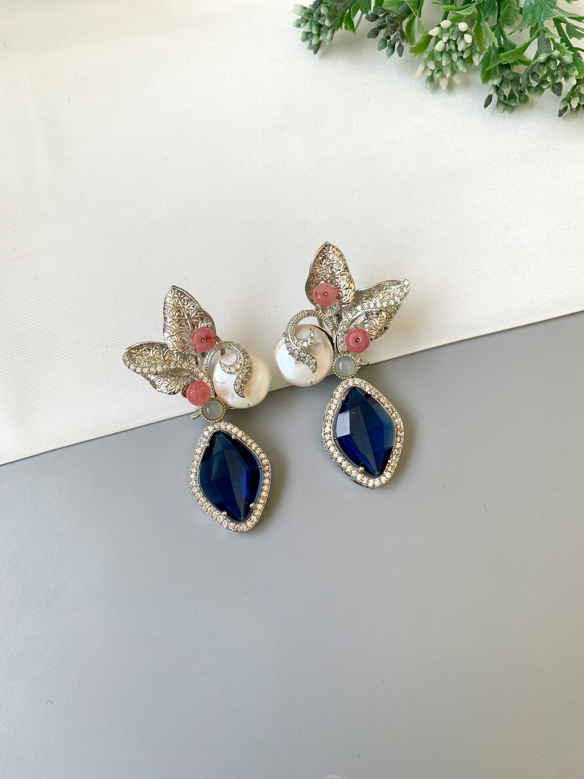 Krisha designer earrings in rhodium foil finish with baroque pearls, sapphire and onyx gemstones