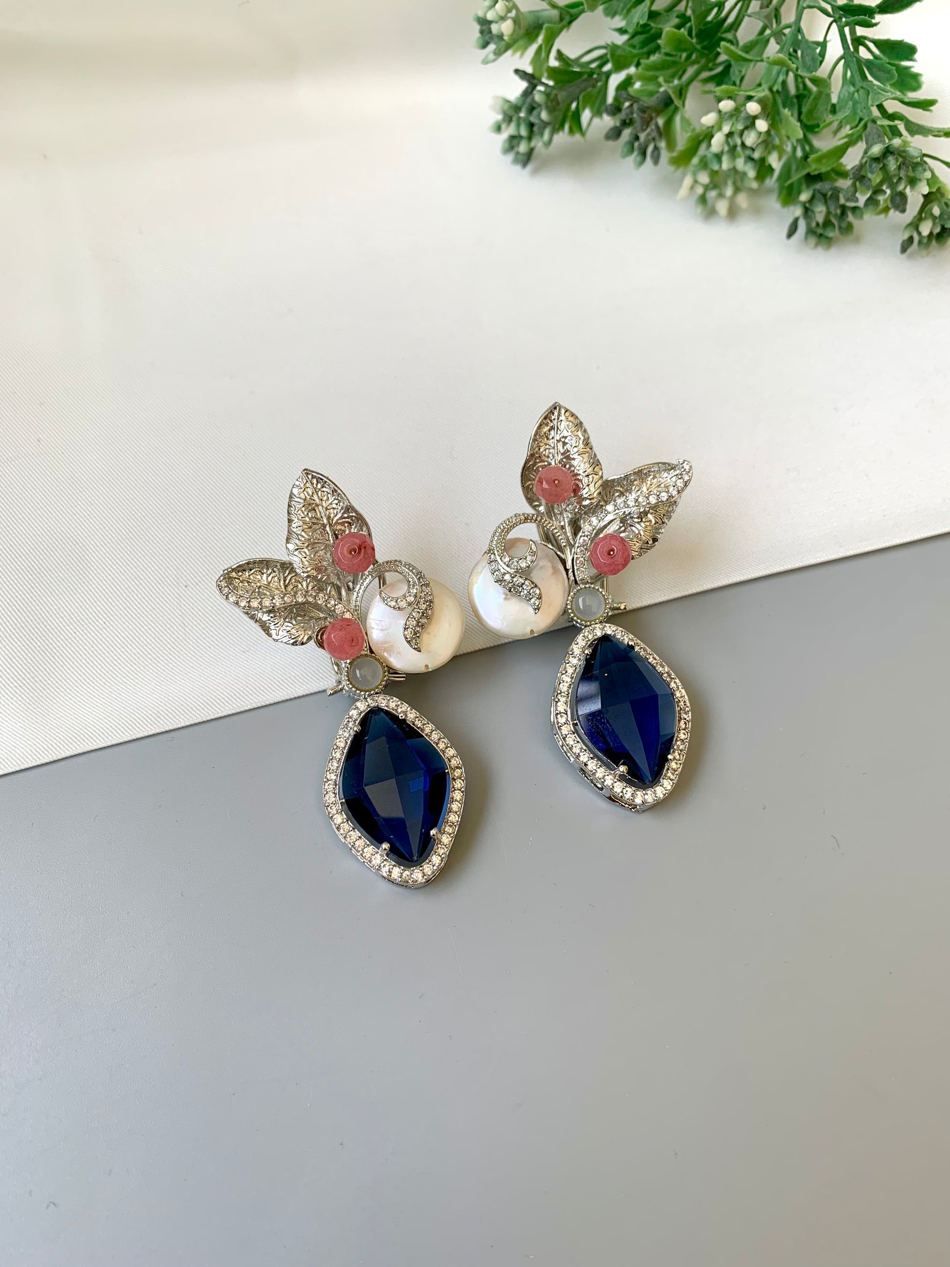 Krisha designer earrings in rhodium foil finish with baroque pearls, sapphire and onyx gemstones