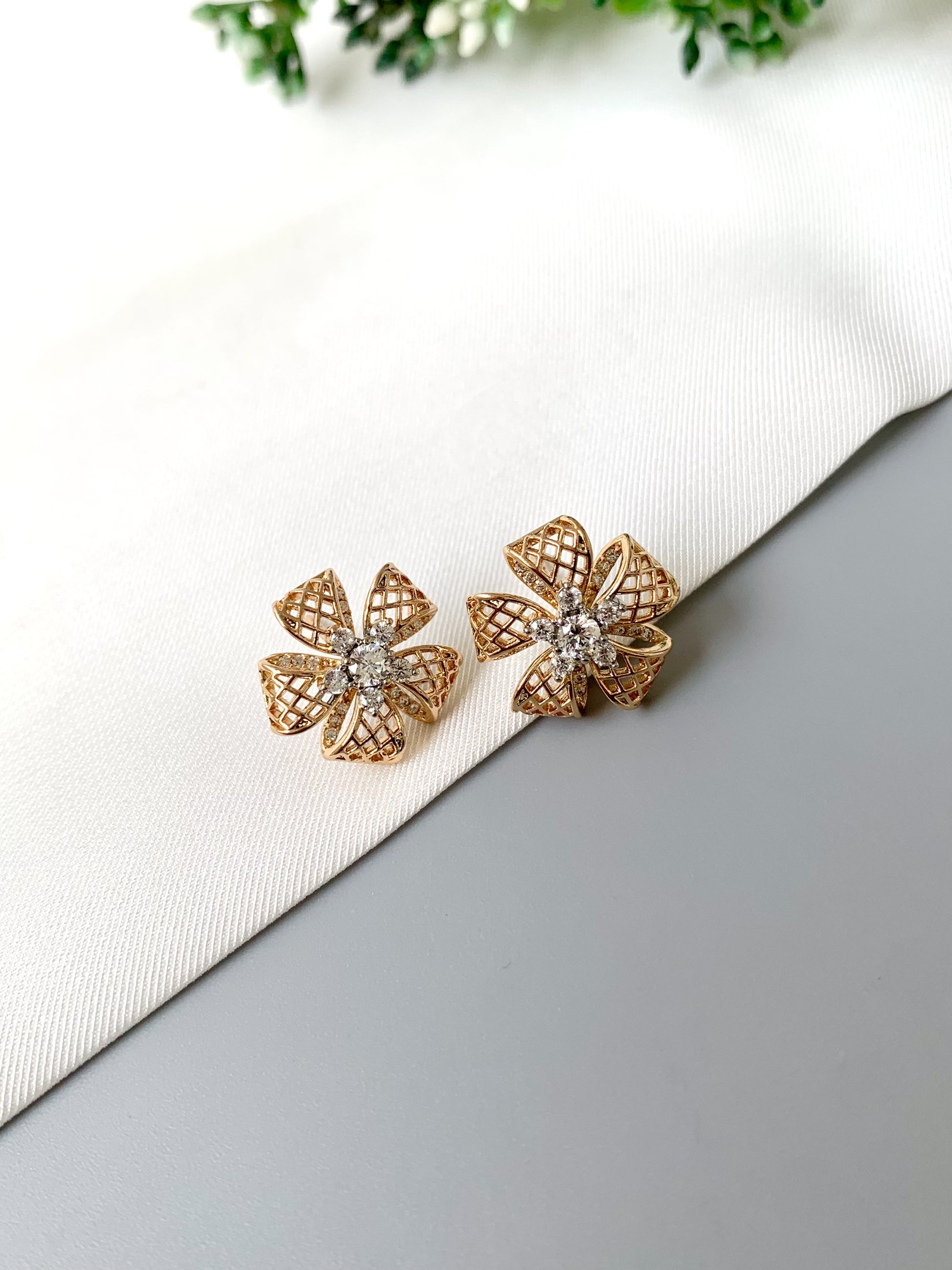 Close-up image of Liora Bloom earrings showing intricate petal design and central diamond cluster.