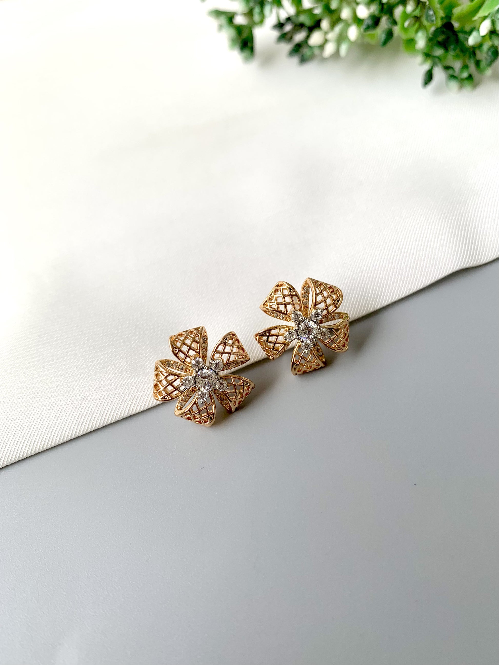 Side view of Liora Bloom floral earrings with open lattice petal design and diamond embellishments.