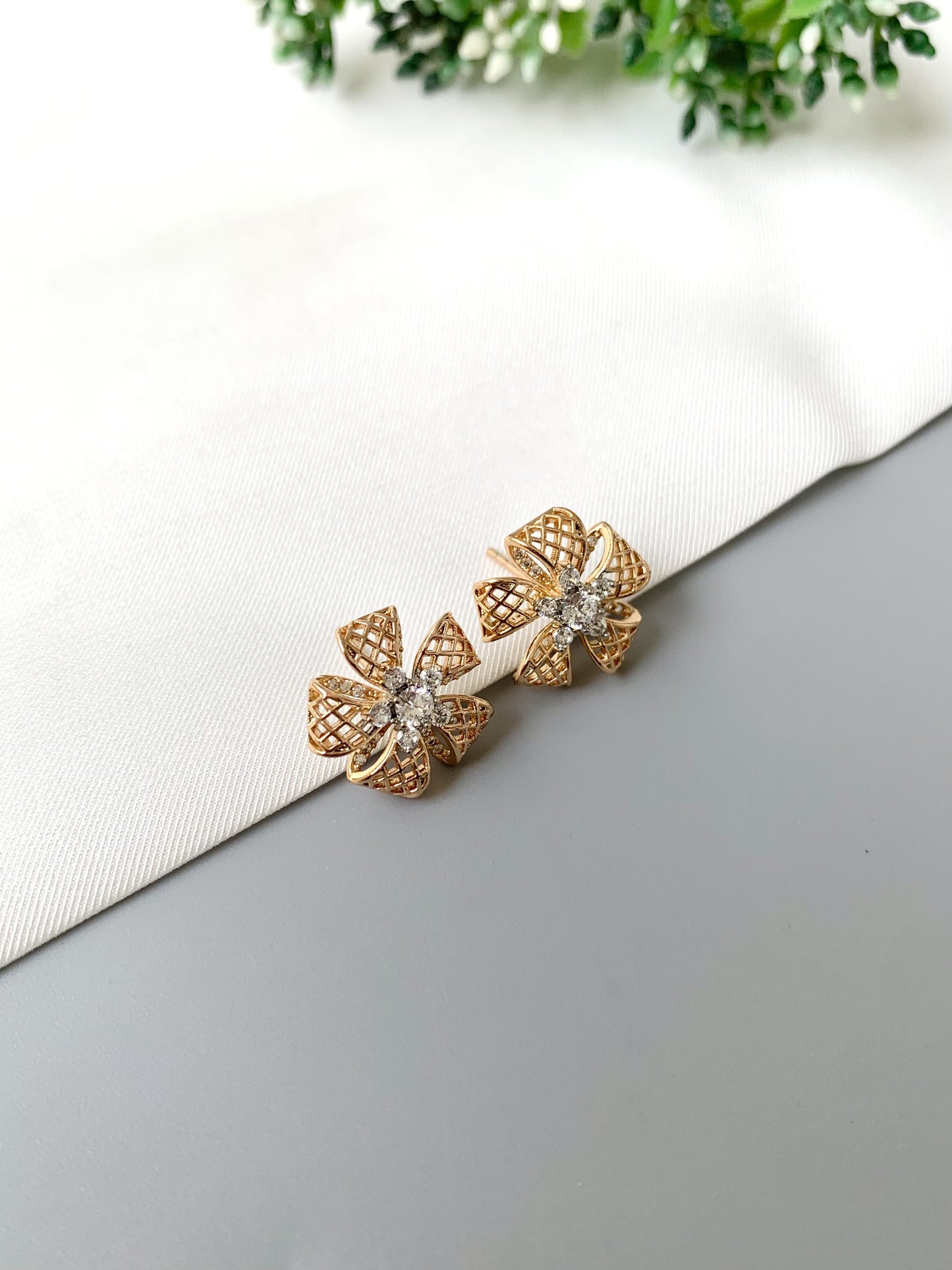 Top-angle view of Liora Bloom studs in 22kt rose gold featuring sparkling American Diamonds.