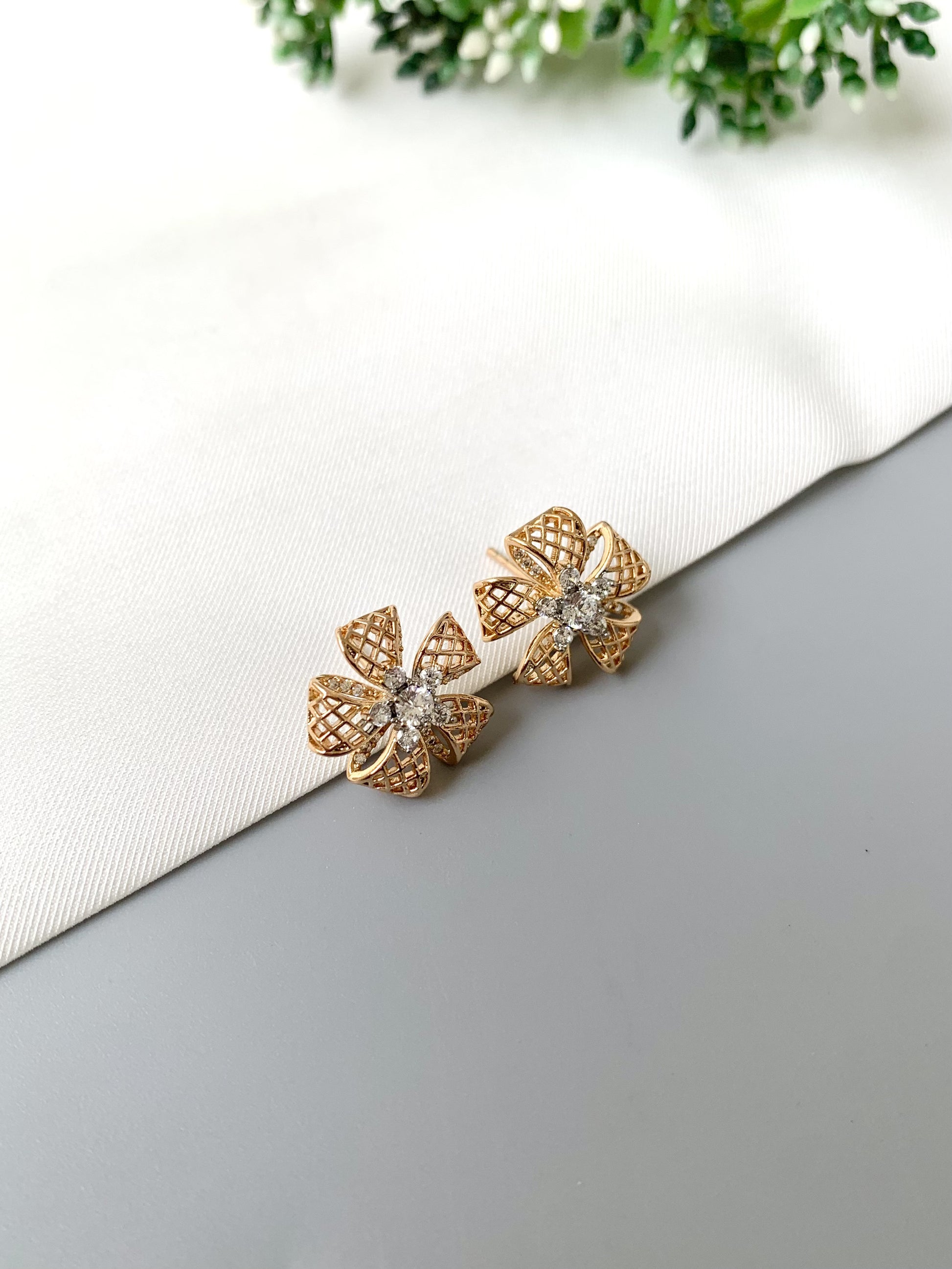 Top-angle view of Liora Bloom studs in 22kt rose gold featuring sparkling American Diamonds.