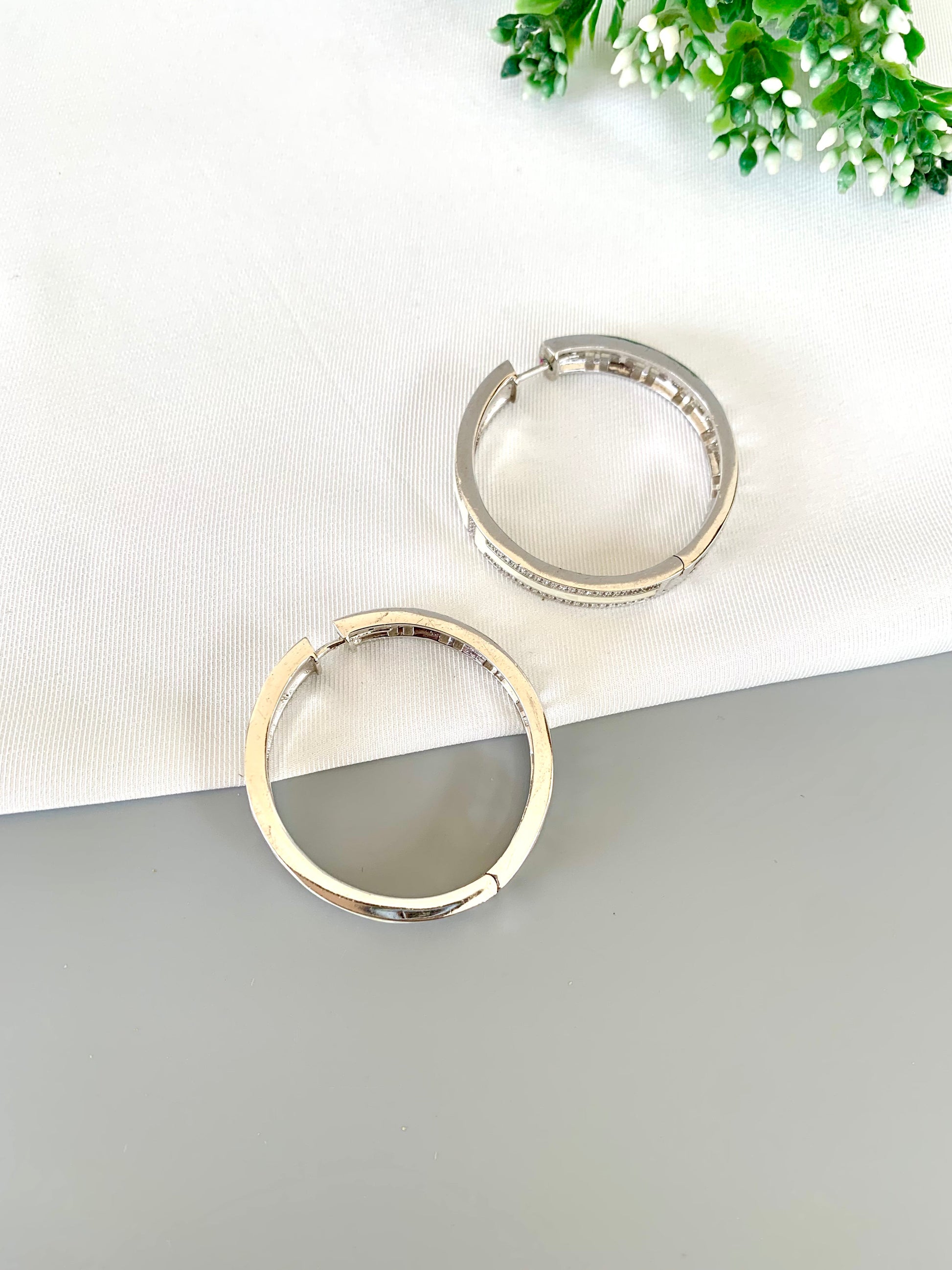 liora-rhodium-hoops-stacked-zamaljewels.jpg
Side-stacked Liora Hoops showcasing full detailing of stones and plating