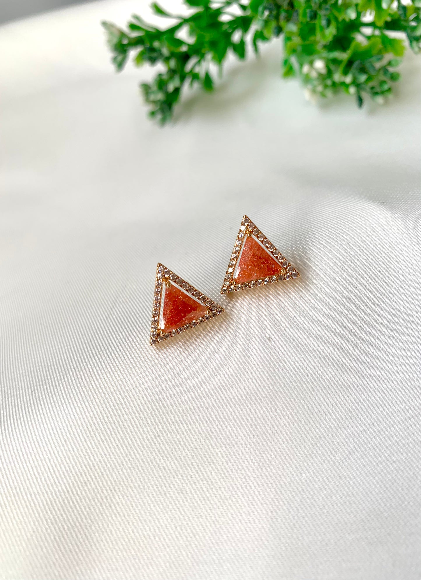 Delicate triangular Lumi studs in 22kt gold plating with American Diamonds and pastel orange natural milky stone