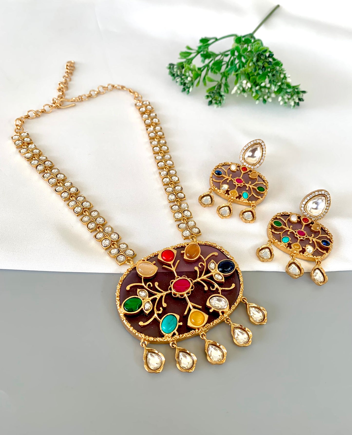 Close-up of Nauratan pendant with inlay gemstones and american diamonds