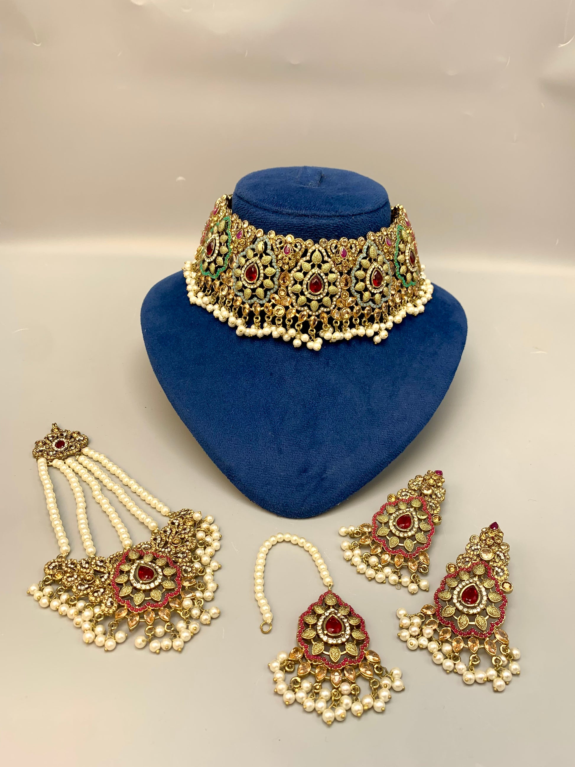 Maniya handcrafted bridal choker set in 22kt gold plating with American diamonds, semi-precious rubies, polki, champagne stones, pearls, jhoomar and tikka