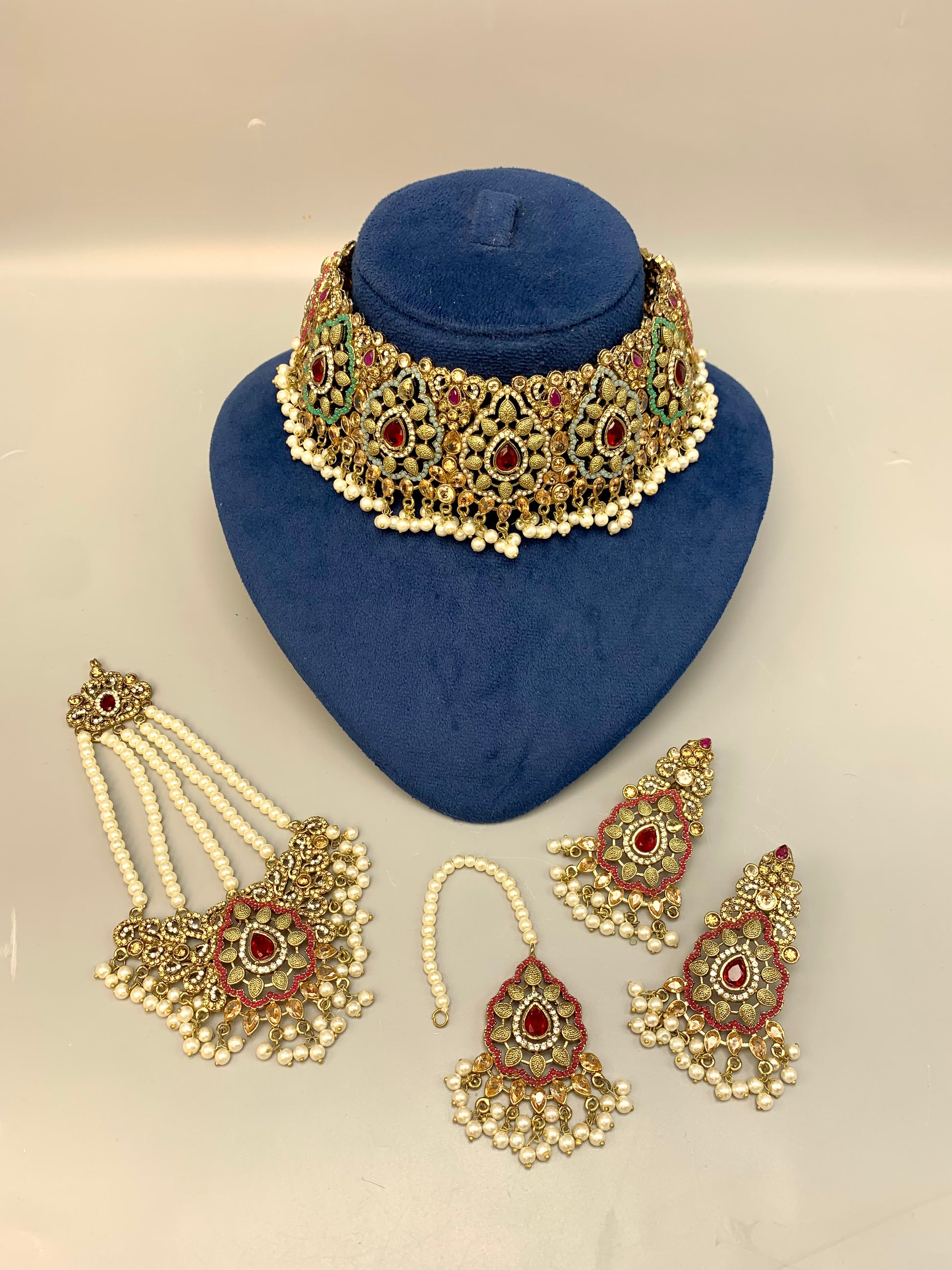 Maniya handcrafted bridal choker set in 22kt gold plating with American diamonds, semi-precious rubies, polki, champagne stones, pearls, jhoomar and tikka