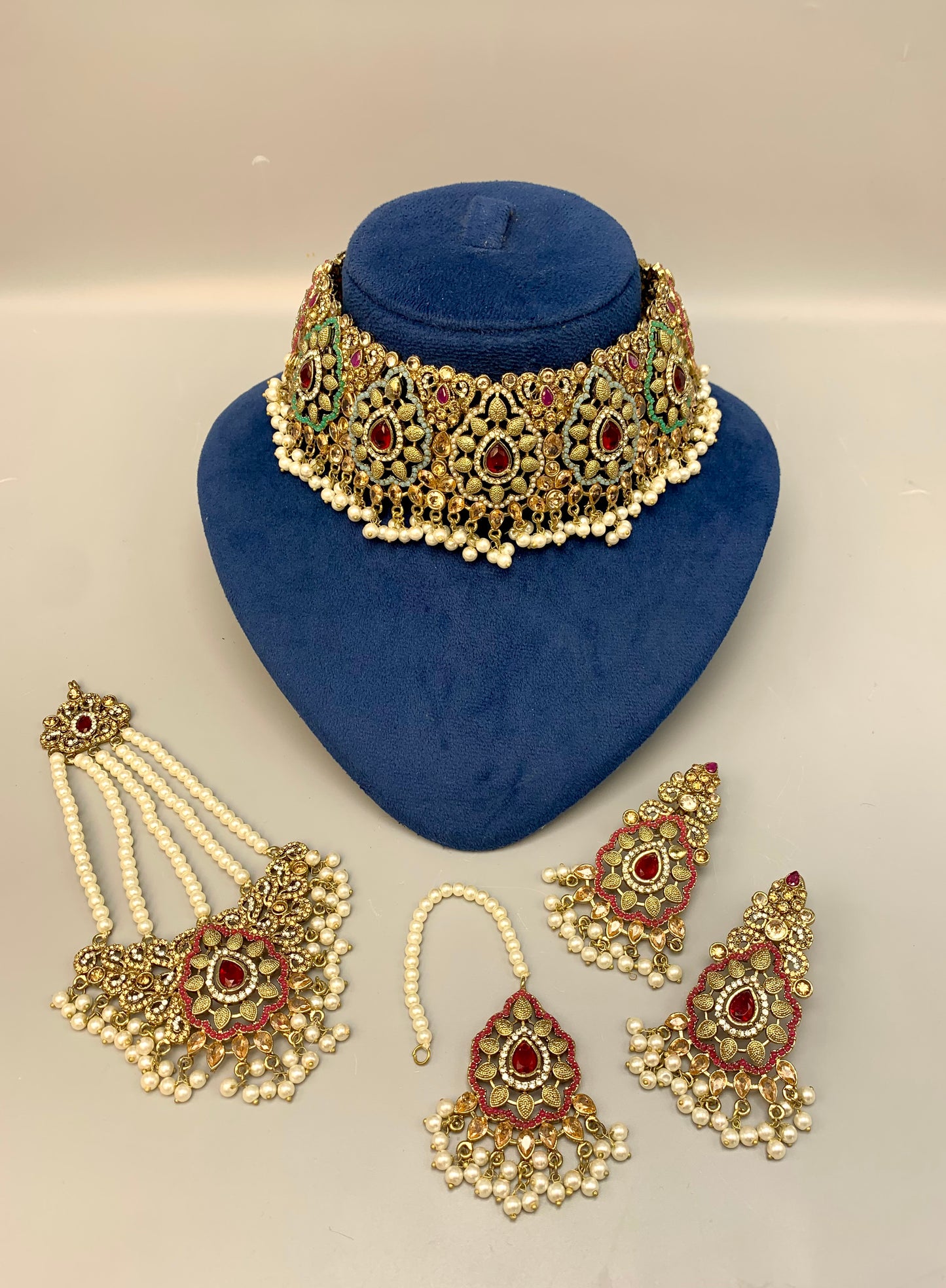 Maniya handcrafted bridal choker set in 22kt gold plating with American diamonds, semi-precious rubies, polki, champagne stones, pearls, jhoomar and tikka