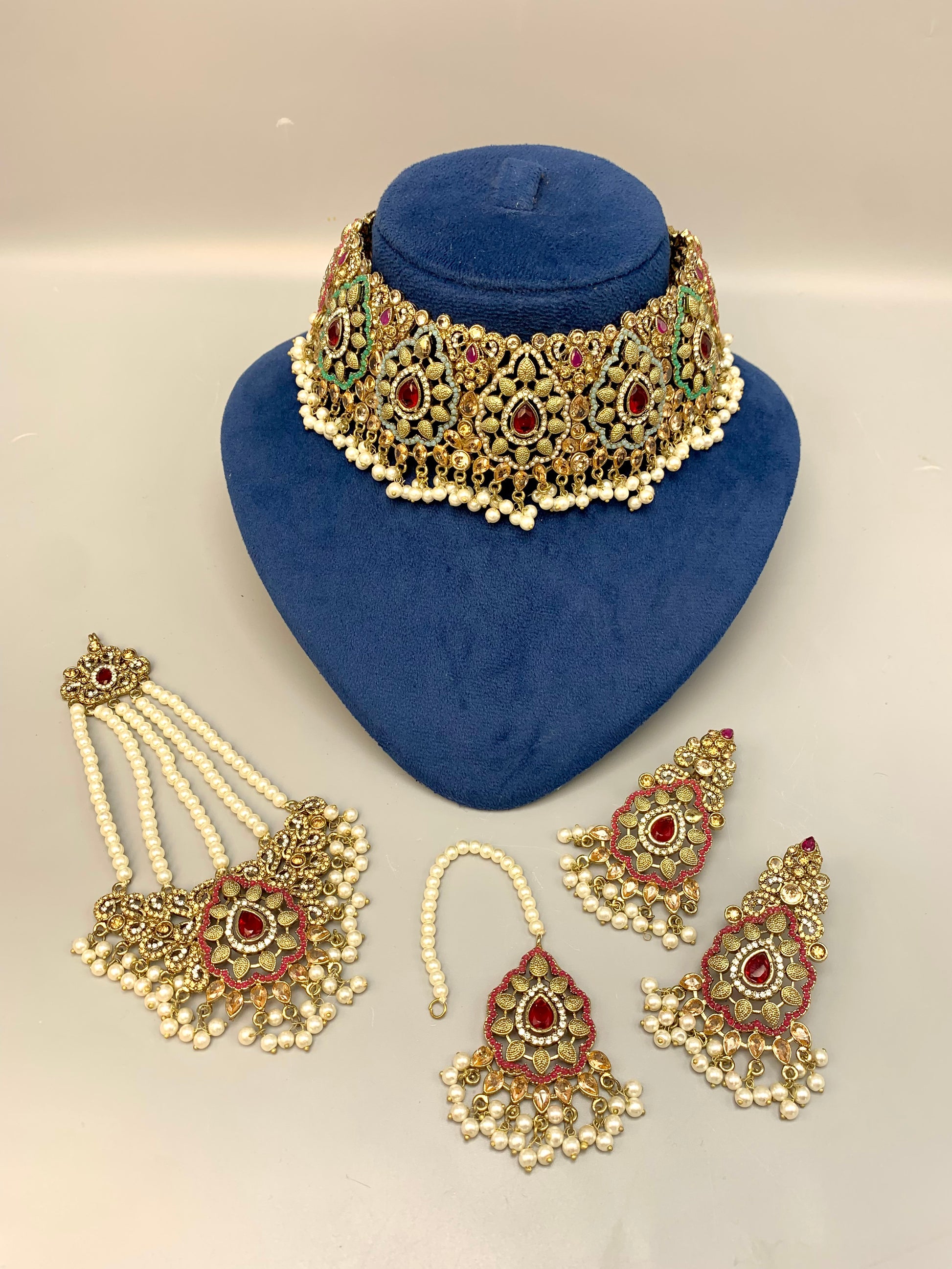 Maniya handcrafted bridal choker set in 22kt gold plating with American diamonds, semi-precious rubies, polki, champagne stones, pearls, jhoomar and tikka