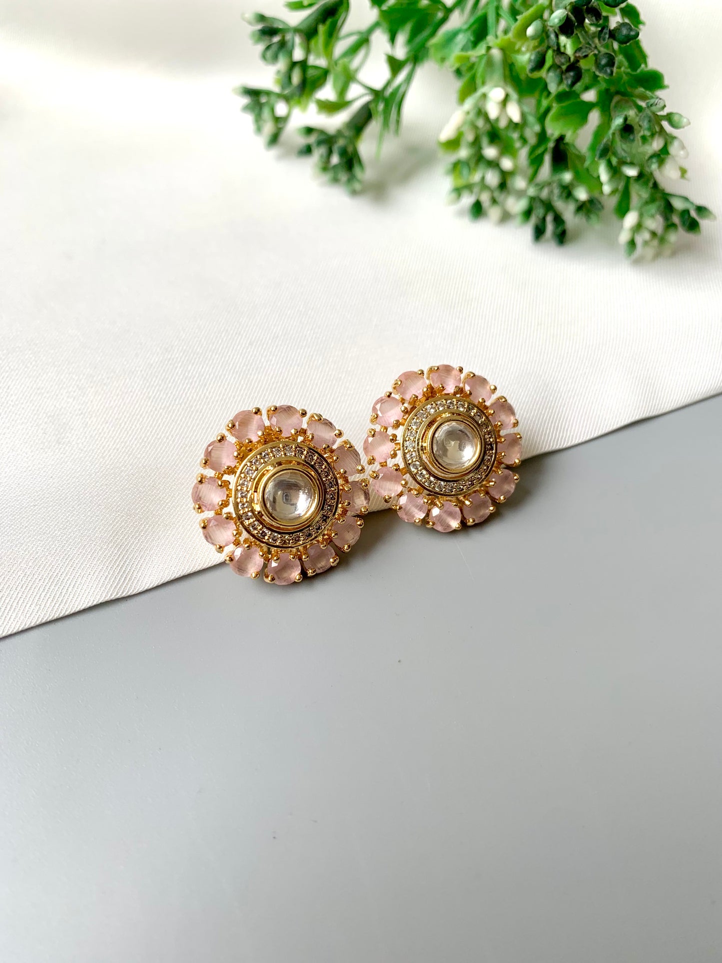 Close-up angled image of Meher Rose Kundan Studs showcasing pink petals and diamond center.