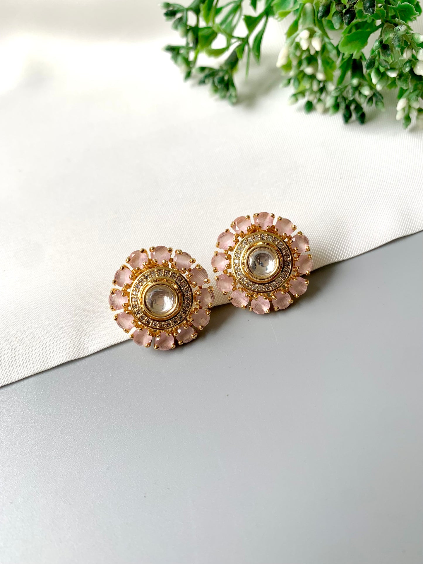 Detailed shot of blush pink Kundan floral studs in rose gold plating.