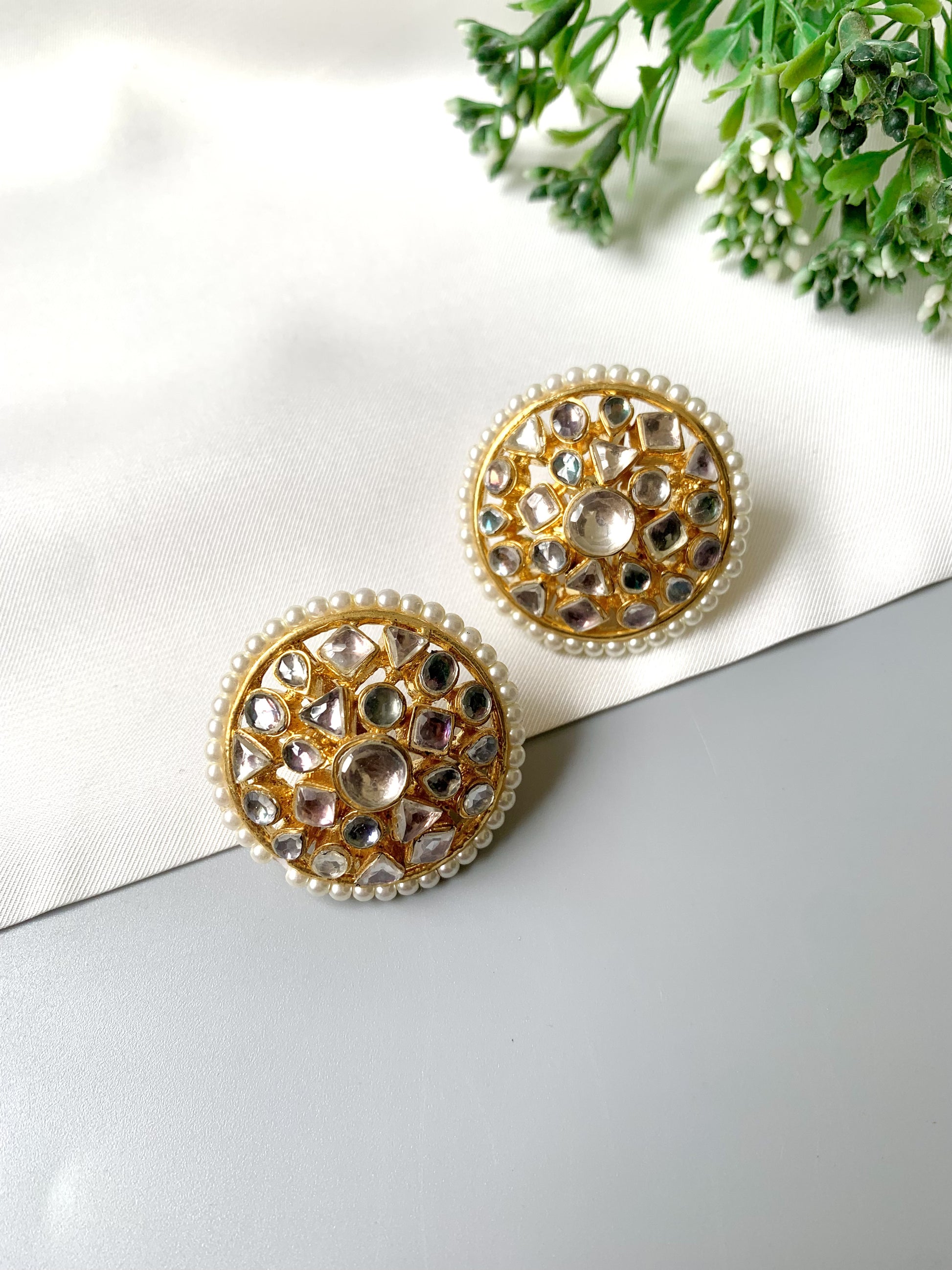 Elegant handcrafted Kundan studs photographed on white background