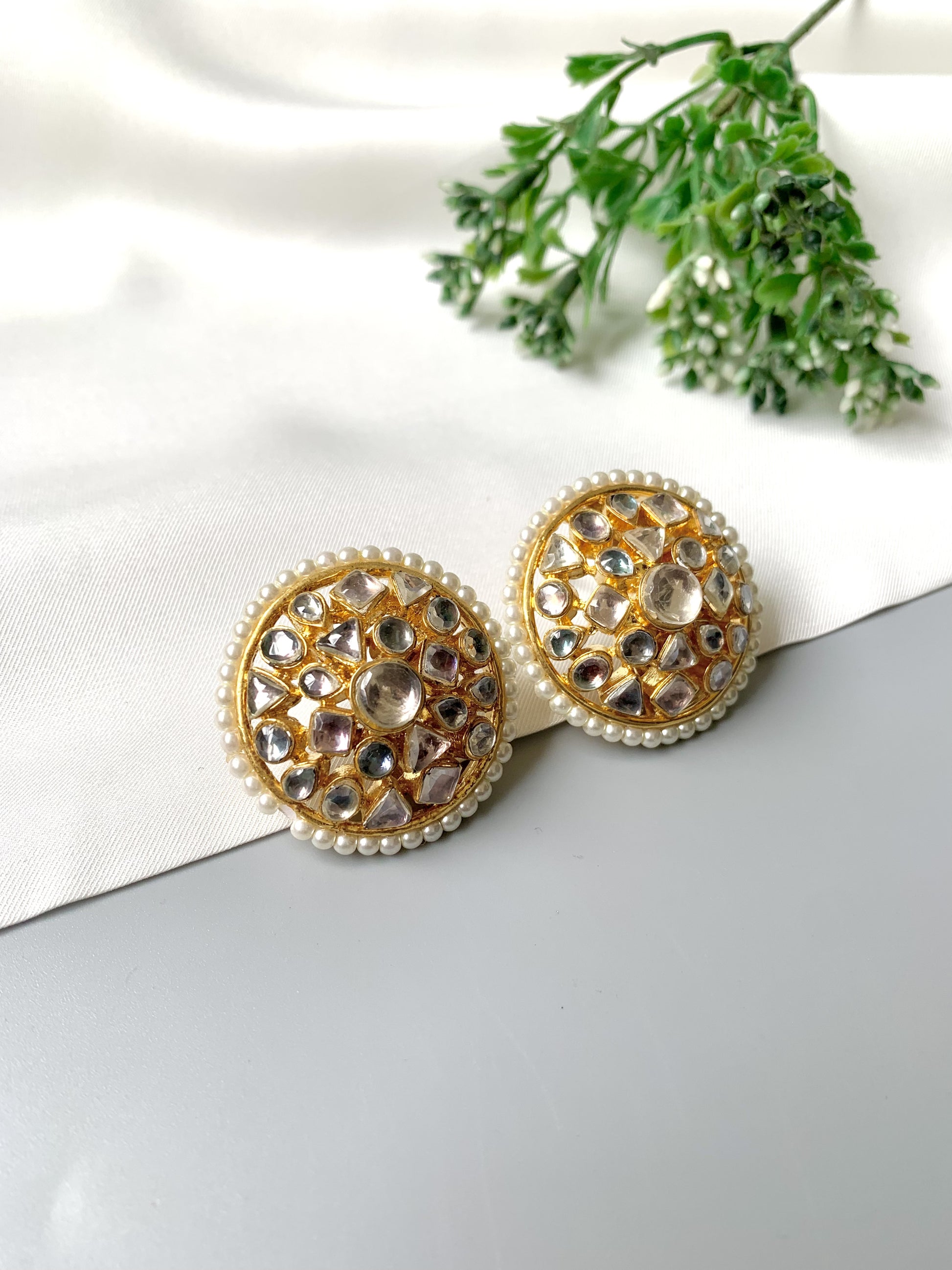 Close-up flatlay of Meherbano Pachi Kundan studs with semi-precious pearls
