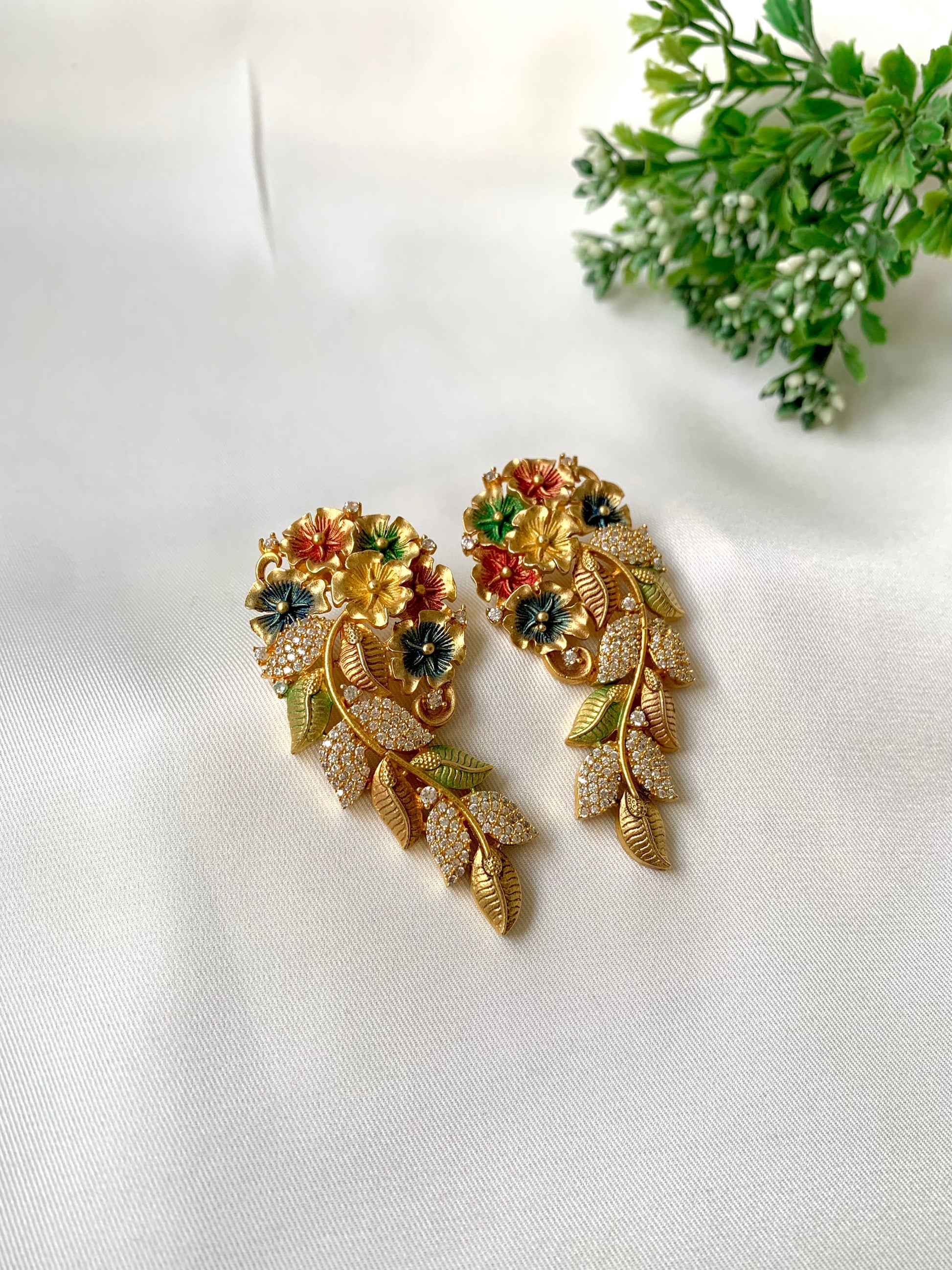 Floral meena earrings with American diamonds in 22kt gold plating