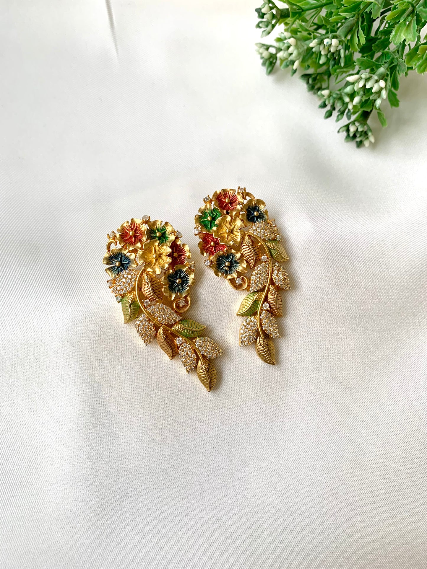 Floral meena earrings with American diamonds in 22kt gold plating