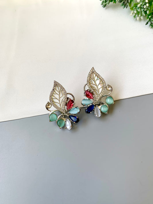 Mila designer studs in rhodium platinum finish with mother of pearl and ruby sapphire onyx gemstones