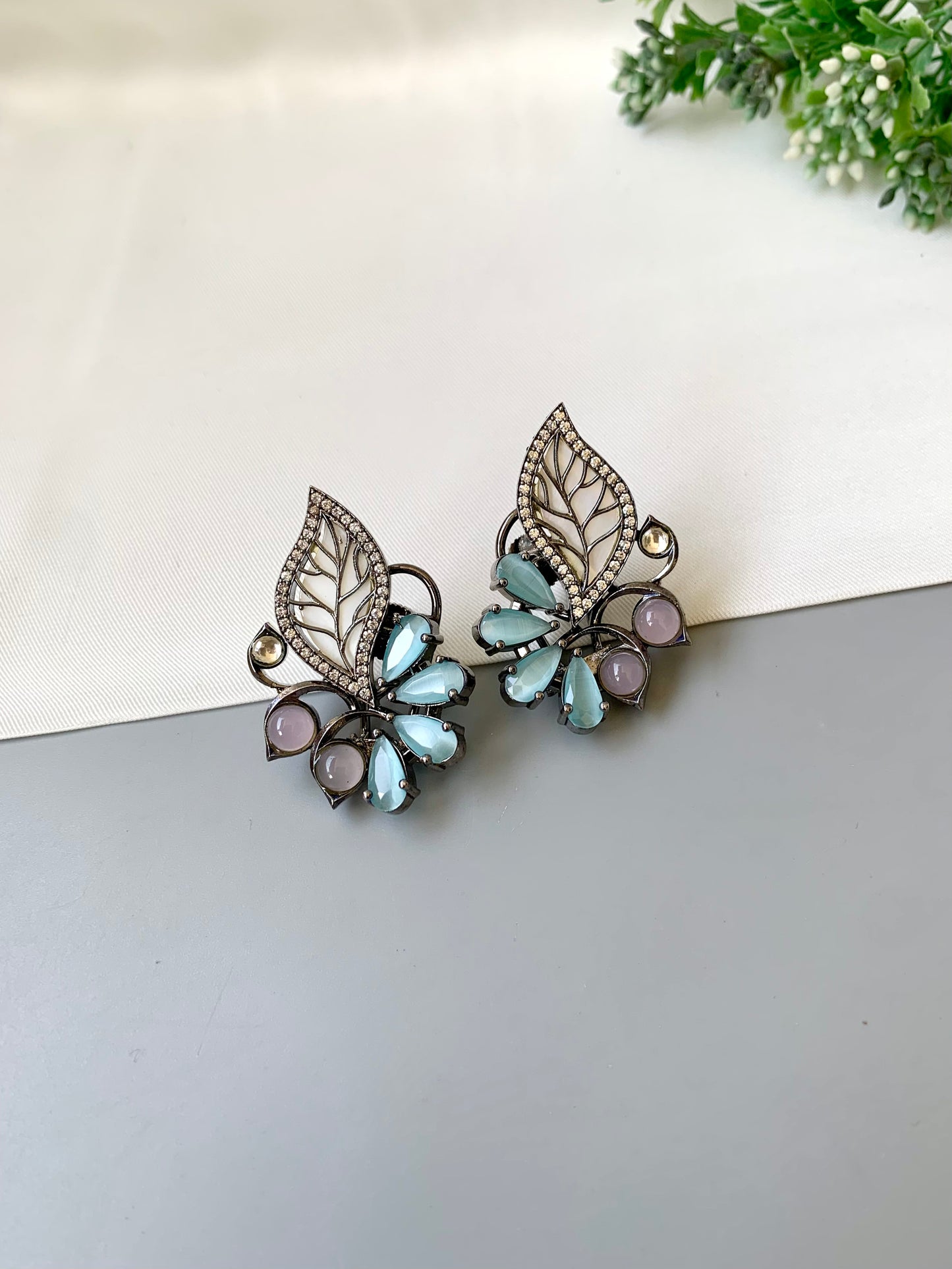Mina polki kundan studs in rhodium oxidized finish with mother of pearl and onyx stones