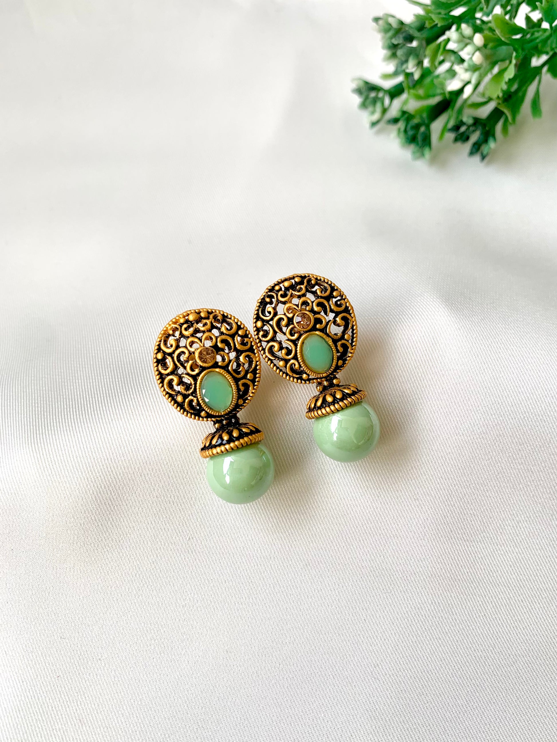 Hand crafted Mira Mint earrings in 22kt gold plating with reverse American diamonds and semi-precious Onyx stones