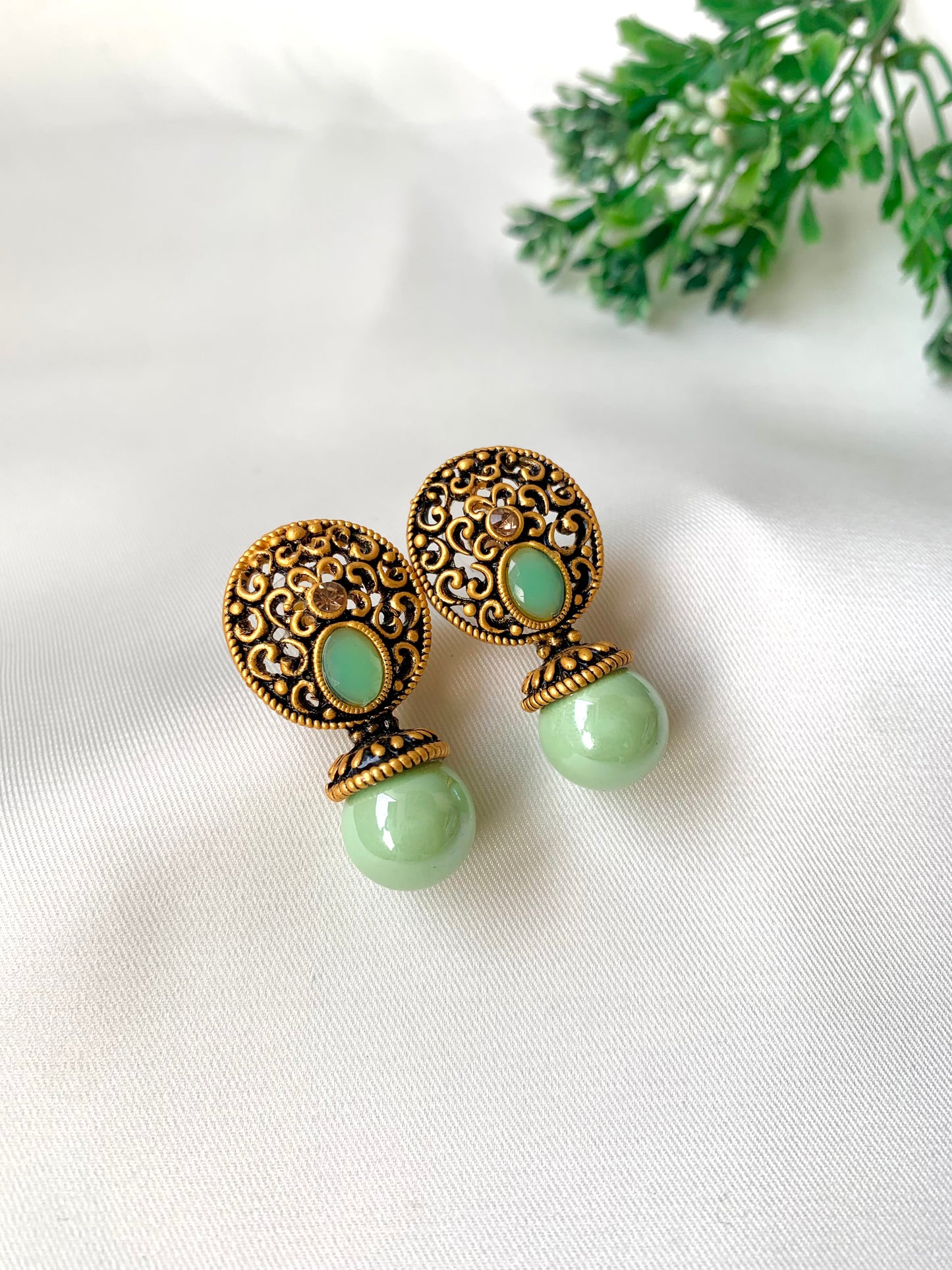 Hand crafted Mira Mint earrings in 22kt gold plating with reverse American diamonds and semi-precious Onyx stones