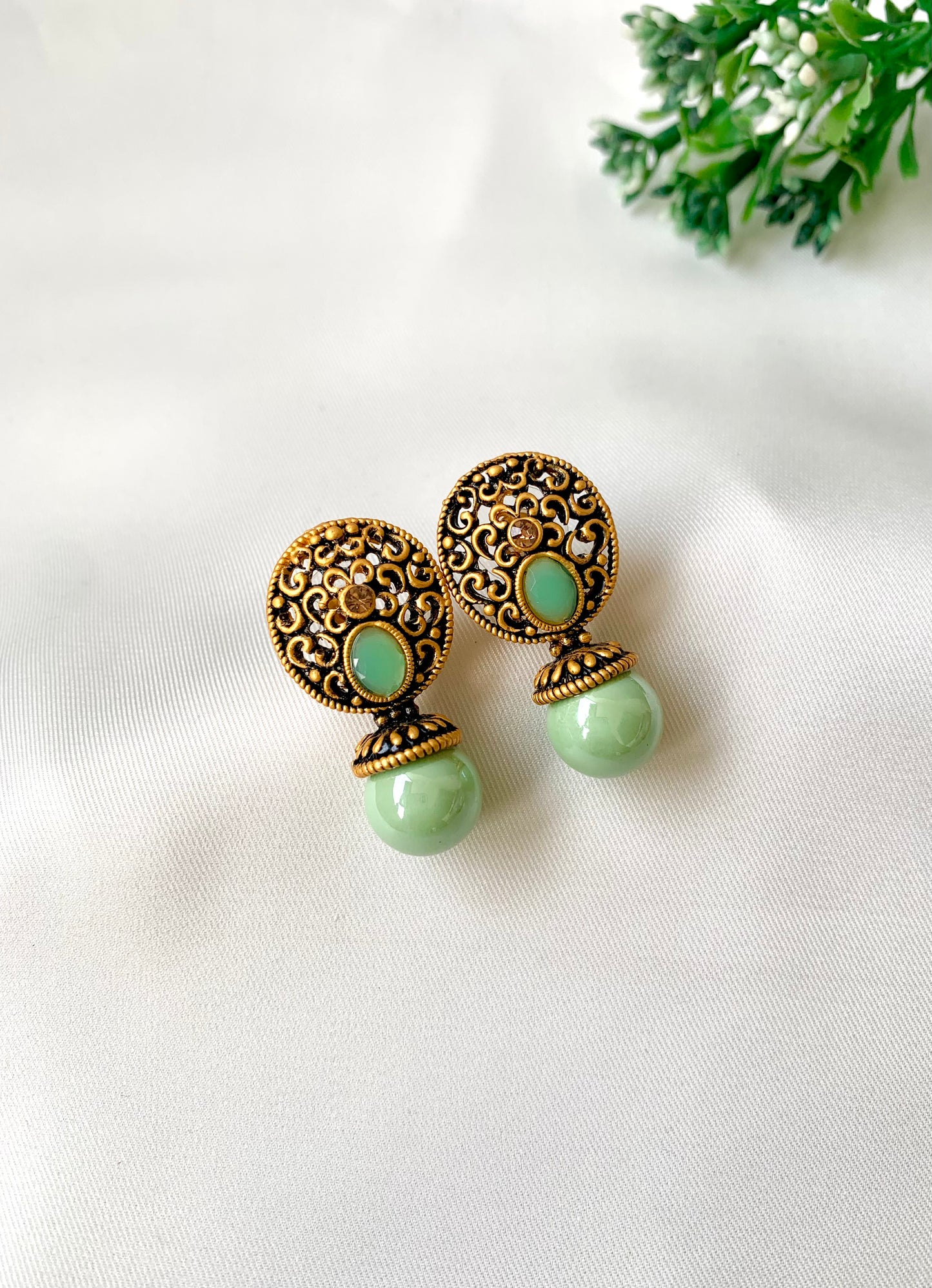 Hand crafted Mira Mint earrings in 22kt gold plating with reverse American diamonds and semi-precious Onyx stones