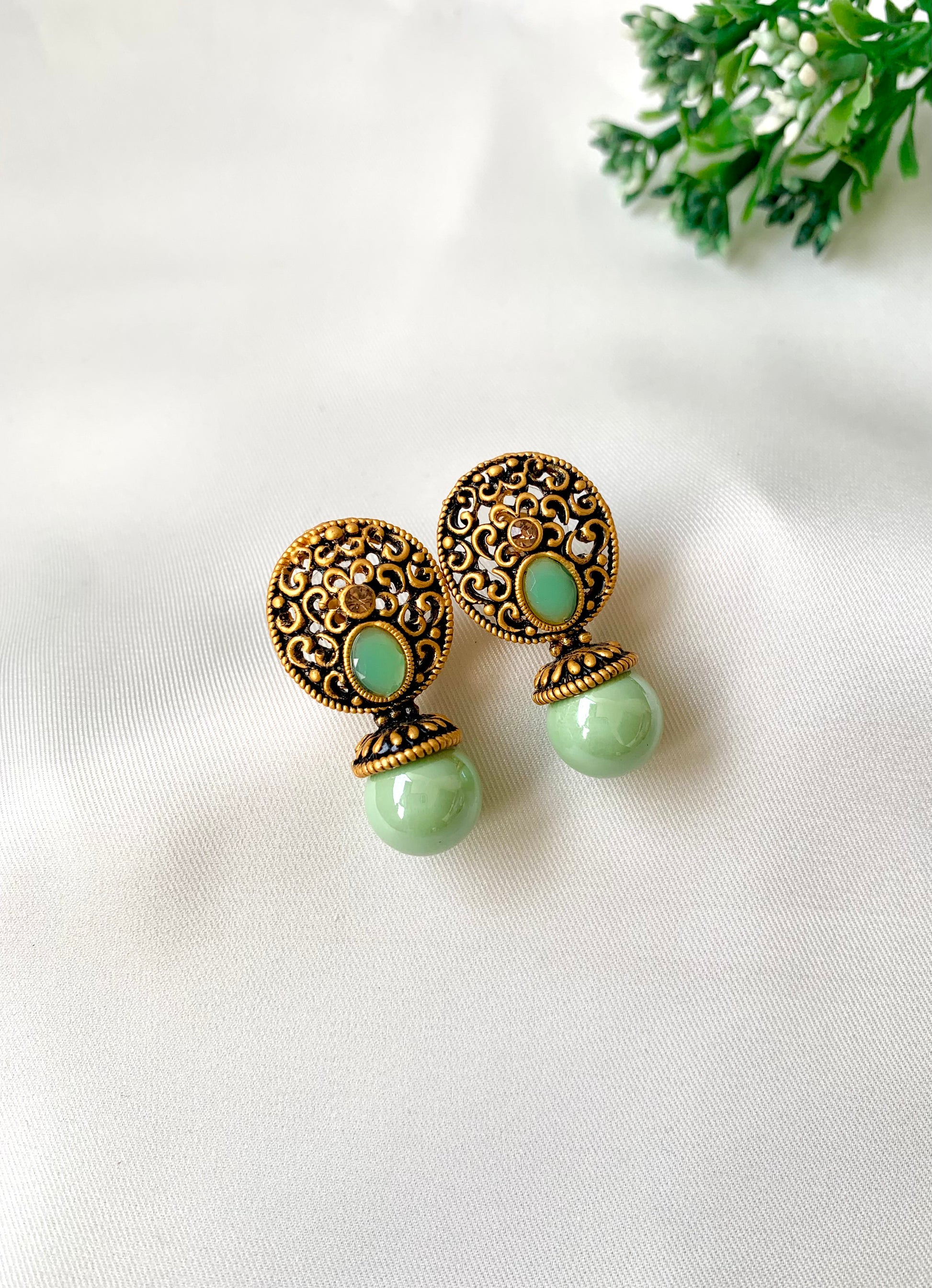 Hand crafted Mira Mint earrings in 22kt gold plating with reverse American diamonds and semi-precious Onyx stones