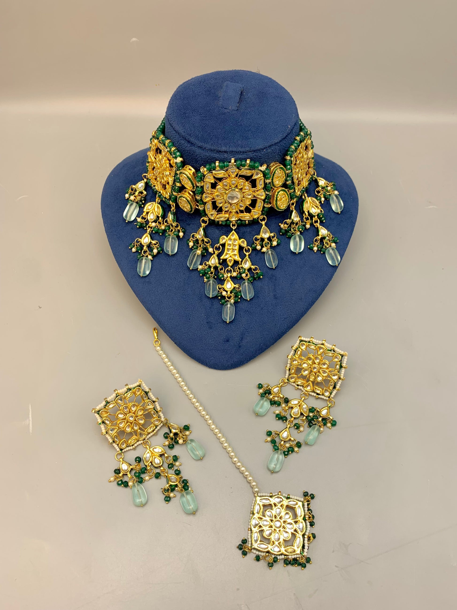 Nehaal handcrafted 22kt gold plated bridal choker set with Bikaneri Kundan, hand-painted Meena, semi-precious emerald, onyx, pearls, earrings and tikka