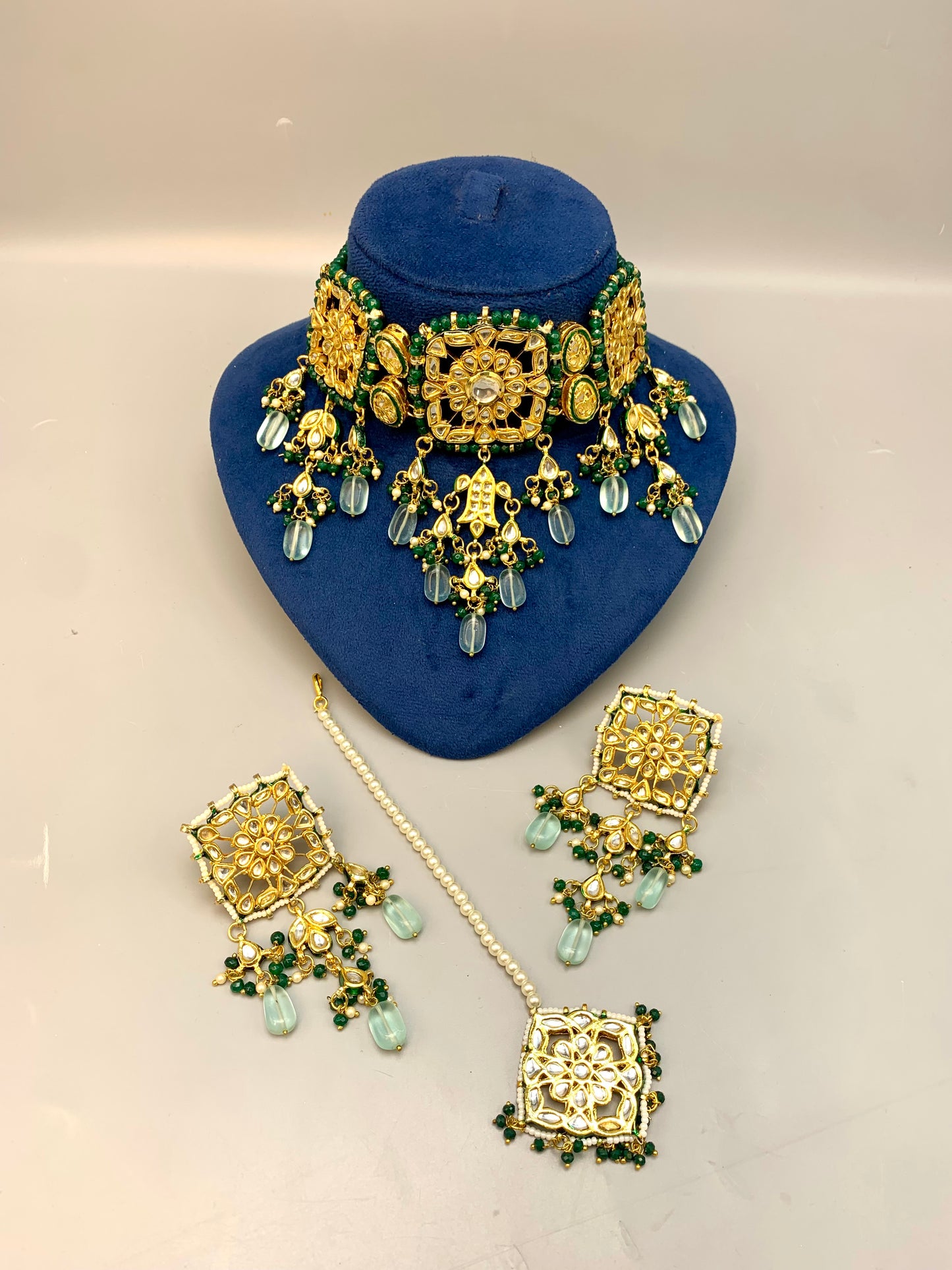 Nehaal handcrafted 22kt gold plated bridal choker set with Bikaneri Kundan, hand-painted Meena, semi-precious emerald, onyx, pearls, earrings and tikka