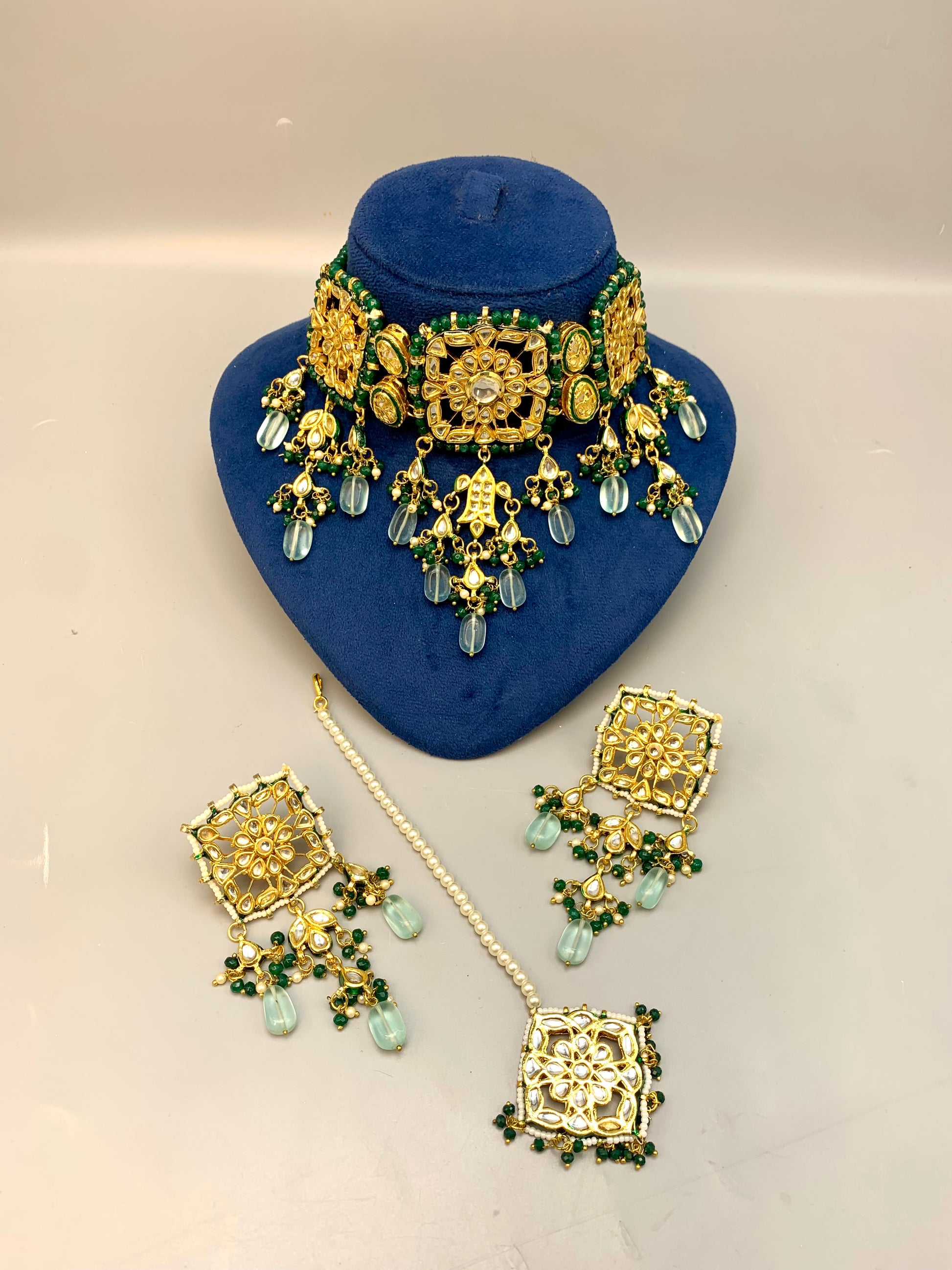 Nehaal handcrafted 22kt gold plated bridal choker set with Bikaneri Kundan, hand-painted Meena, semi-precious emerald, onyx, pearls, earrings and tikka