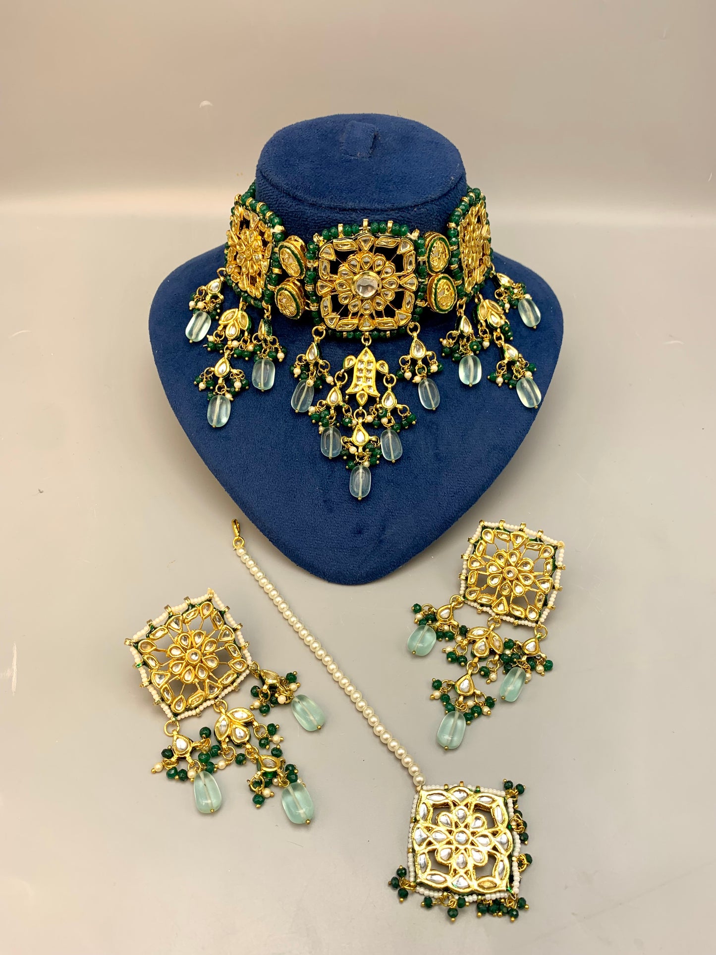 Nehaal handcrafted 22kt gold plated bridal choker set with Bikaneri Kundan, hand-painted Meena, semi-precious emerald, onyx, pearls, earrings and tikka