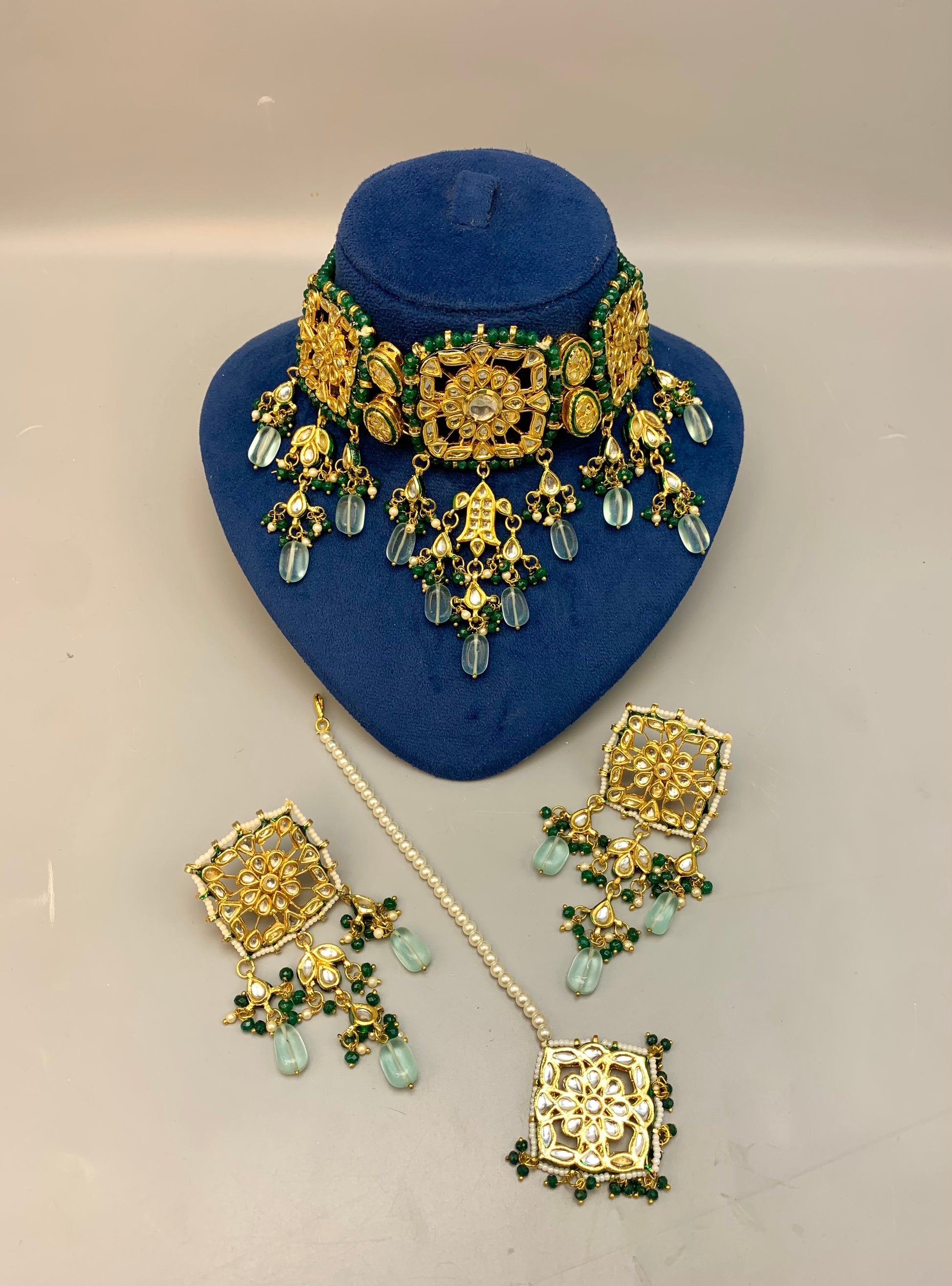 Nehaal handcrafted 22kt gold plated bridal choker set with Bikaneri Kundan, hand-painted Meena, semi-precious emerald, onyx, pearls, earrings and tikka