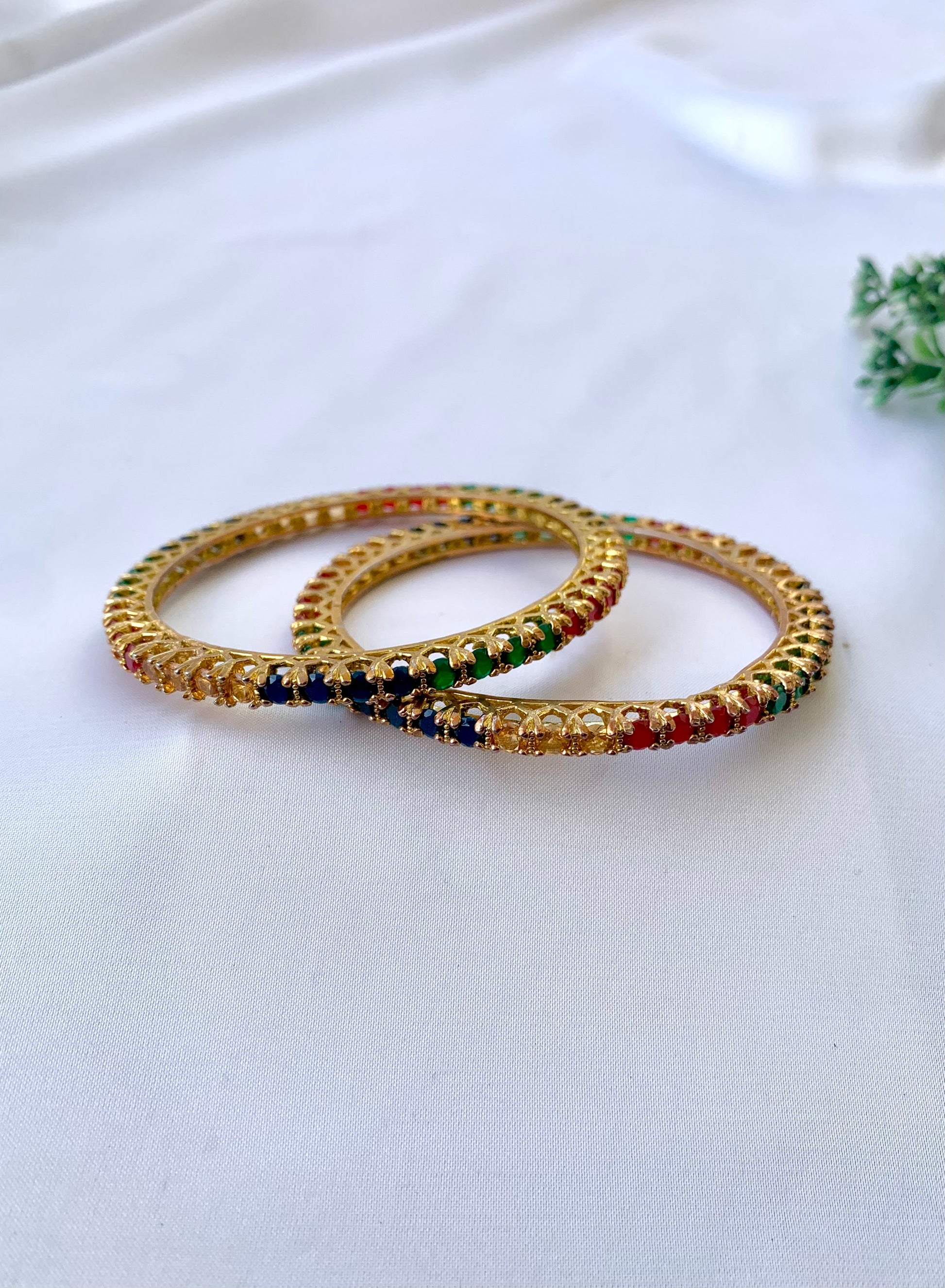 Handcrafted Neriah Bangles in 22kt gold plating with reverse Semi-Precious Ruby, Emerald, Sapphire, and Champagne stones