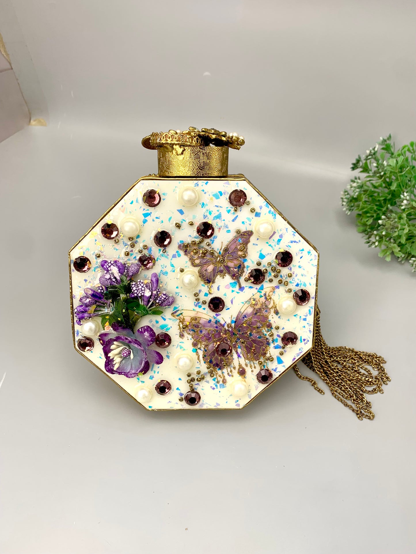 Noor handcrafted gold plated clutch with butterfly and floral gemstone embellishments