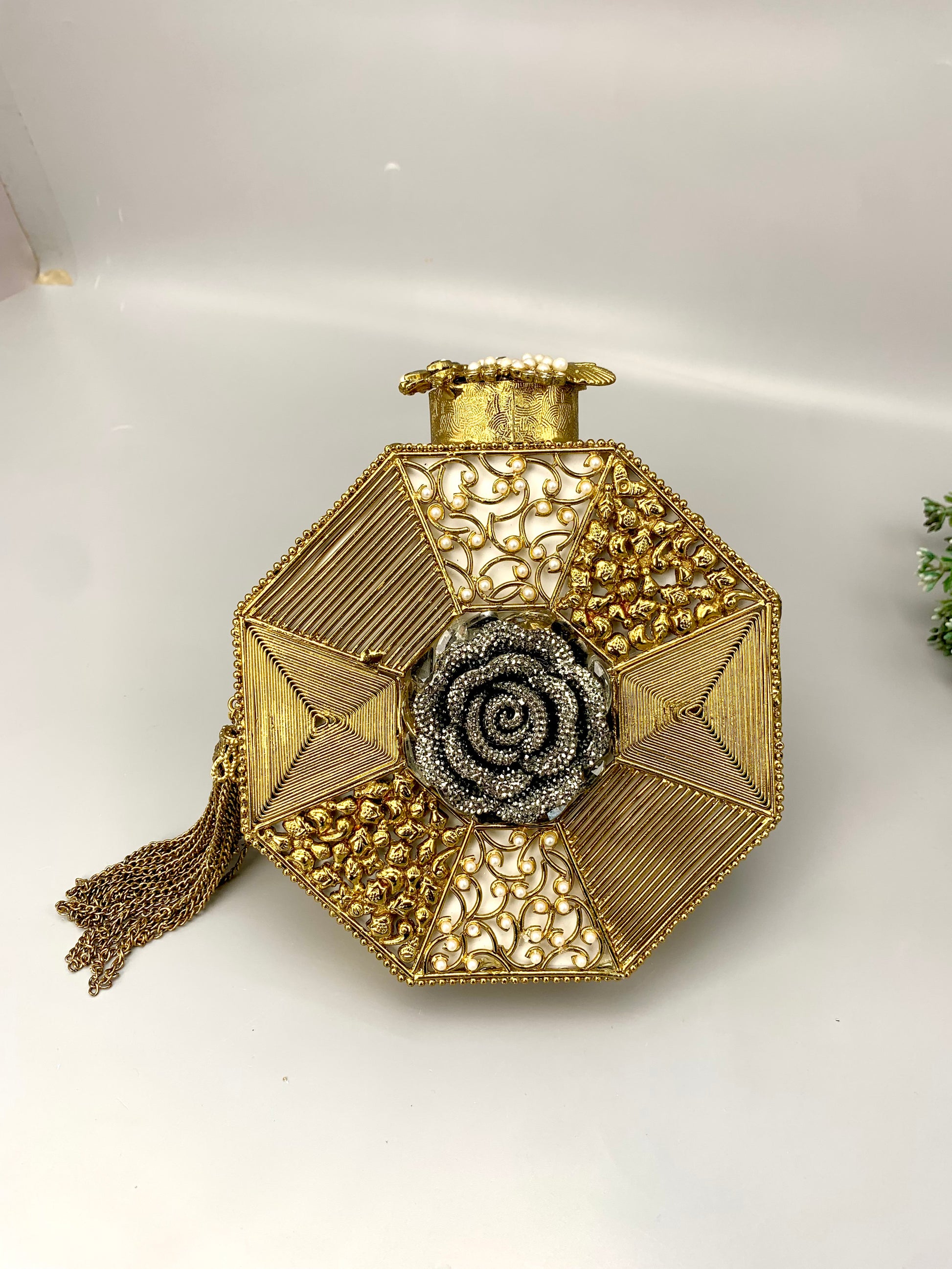 Noor handcrafted gold plated clutch with butterfly and floral gemstone embellishments