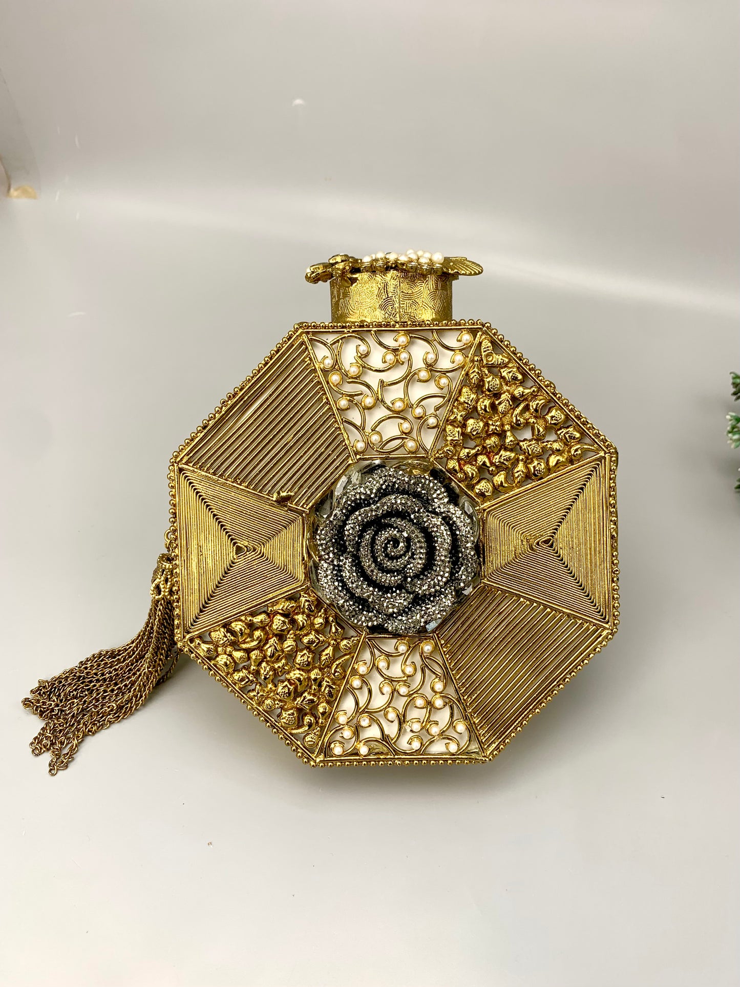 Decorative gold vase with intricate patterns on a white background