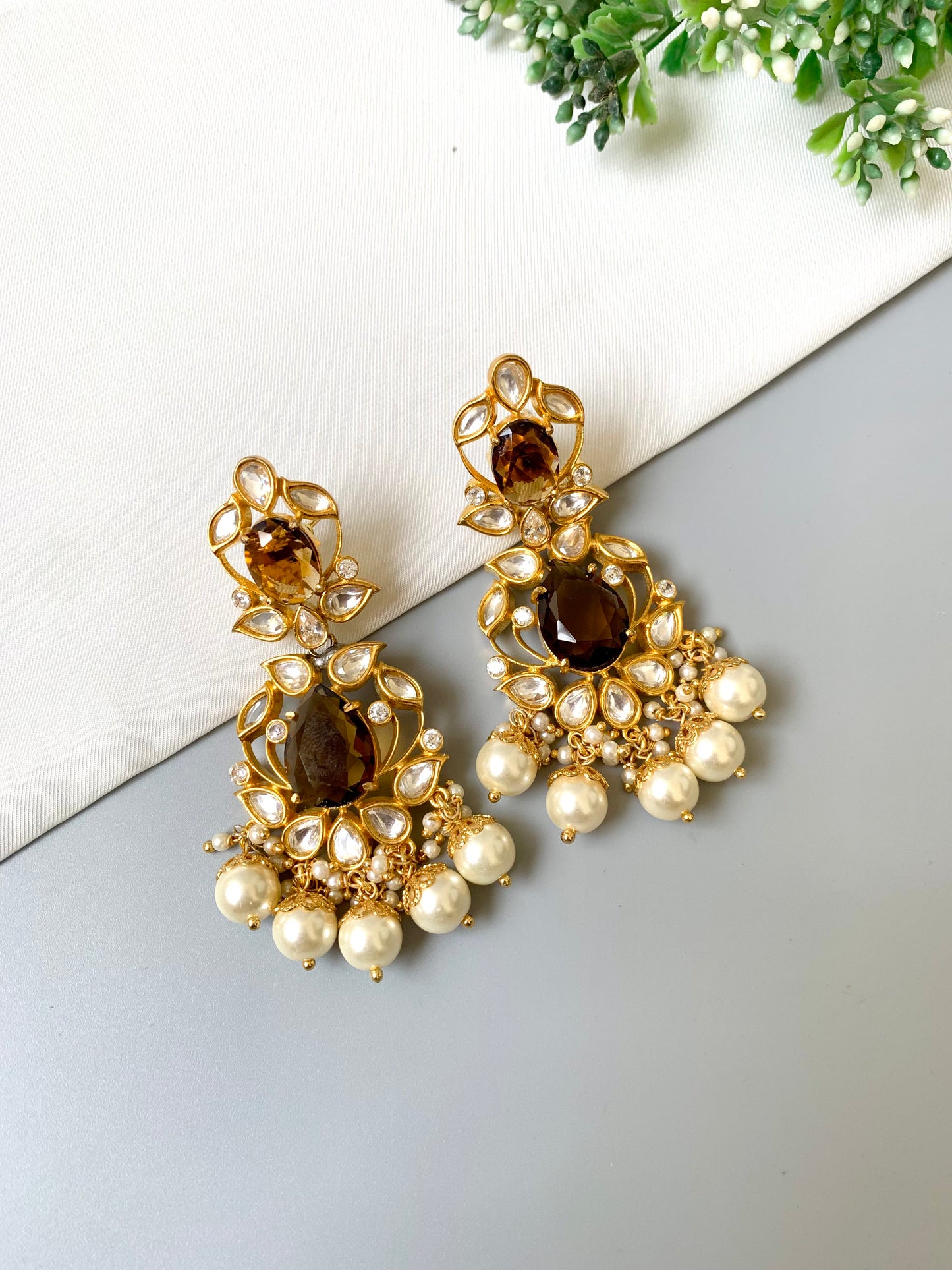 Close-up of Zamal Jewels earrings featuring Polki Kundan, pearls, and smoky quartz in a heritage design