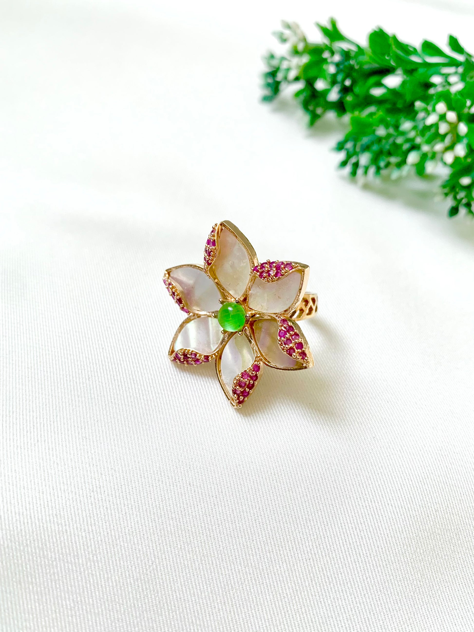 Olivia Ring in floral design with green centre stone and ruby accents – side perspective