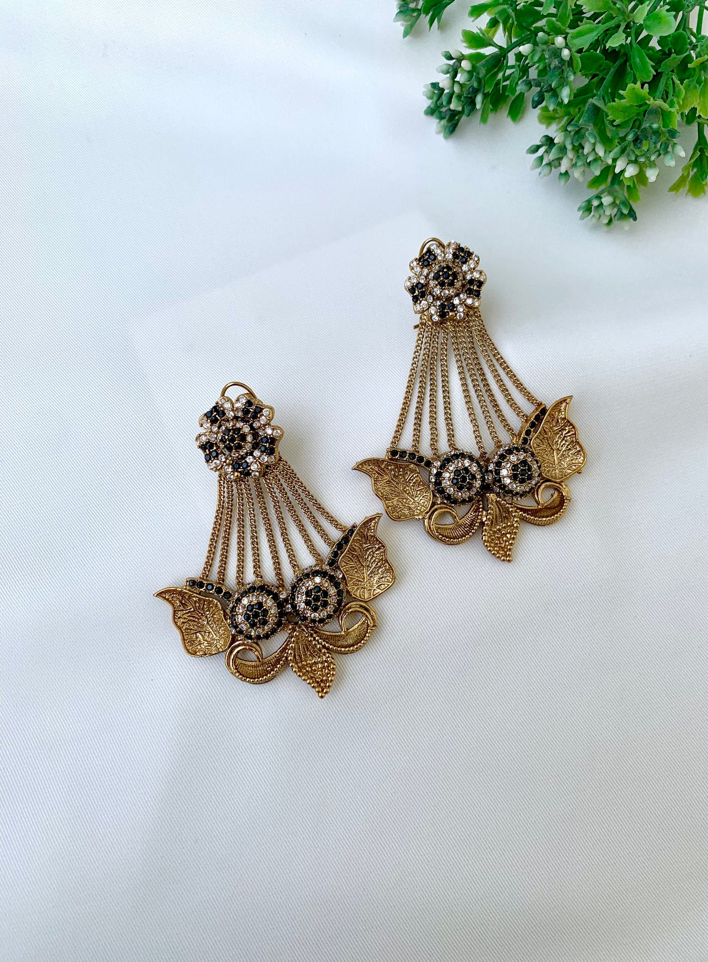 Parvati black jhoomar earrings in gold plating with American diamonds and gemstone detailing