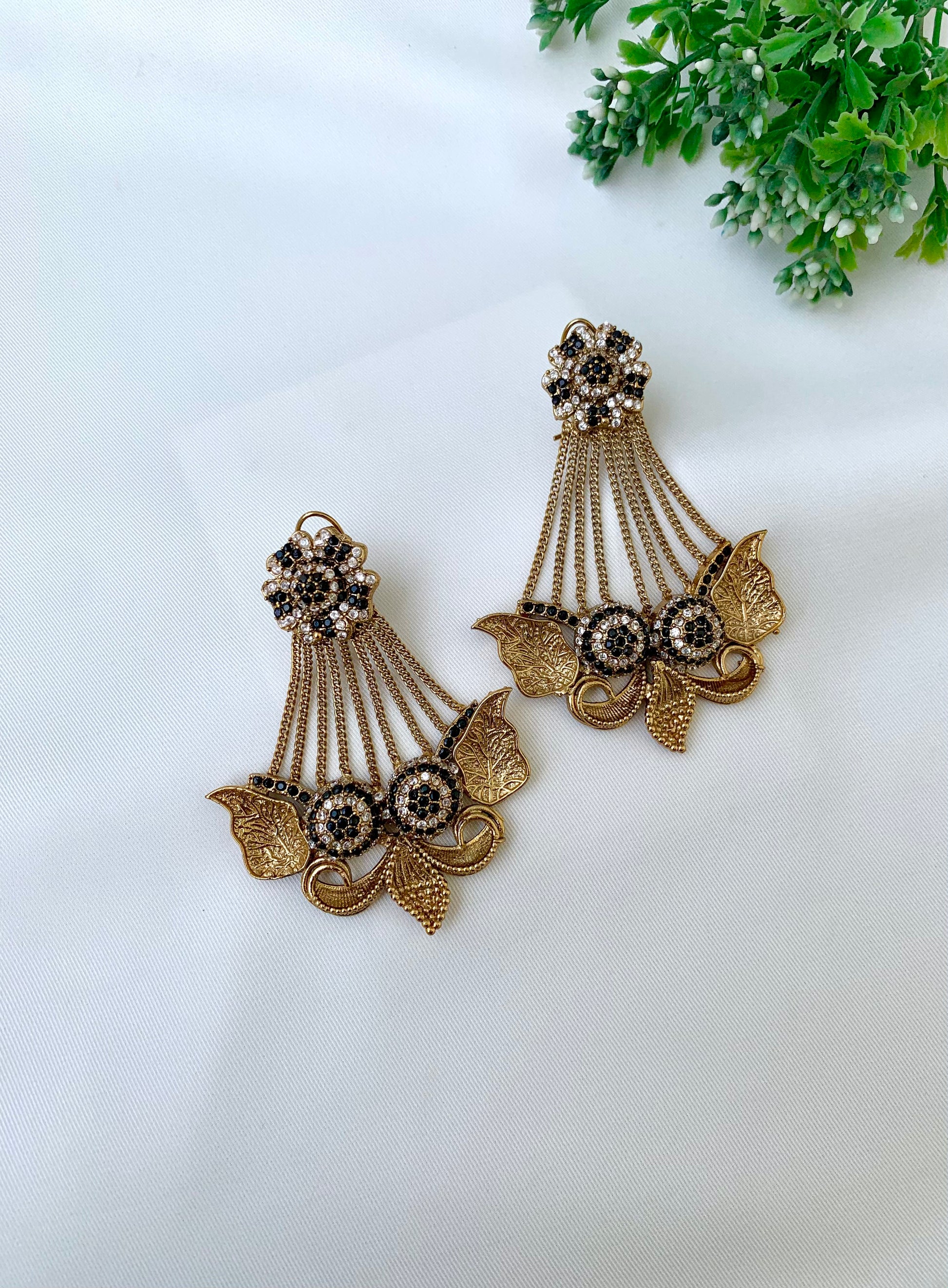 Parvati black jhoomar earrings in gold plating with American diamonds and gemstone detailing