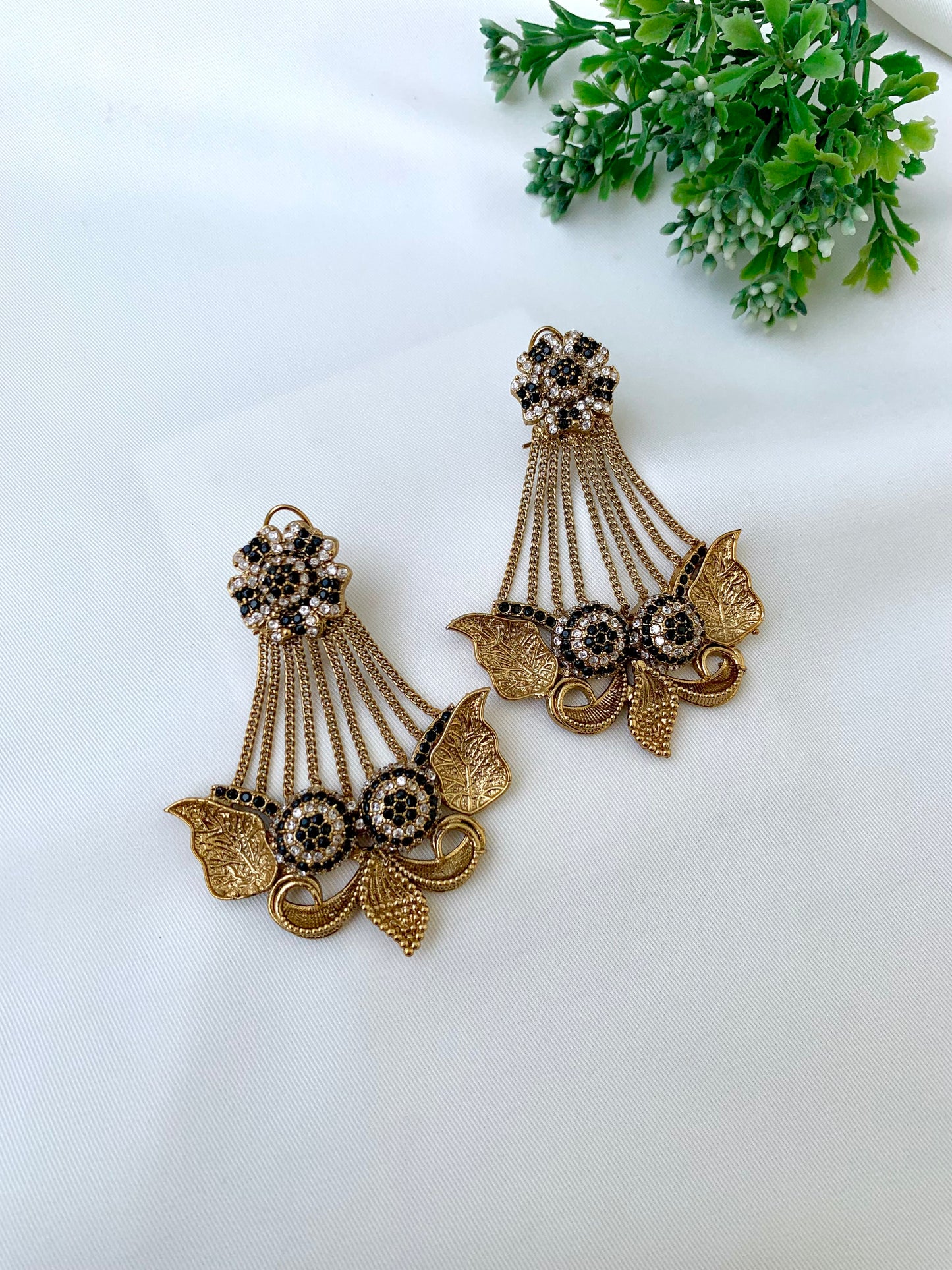 Parvati black jhoomar earrings in gold plating with American diamonds and gemstone detailing