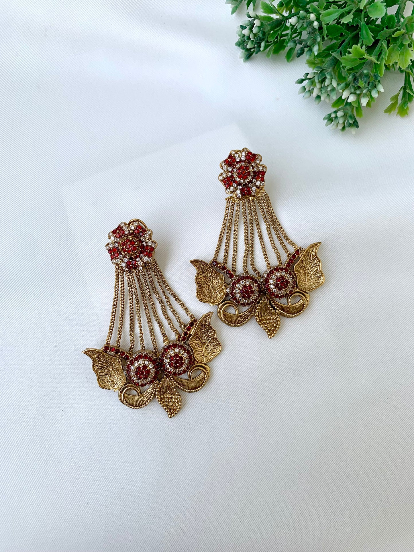 Parvati ruby jhoomar earrings in gold plating with American diamonds and gemstone detailing