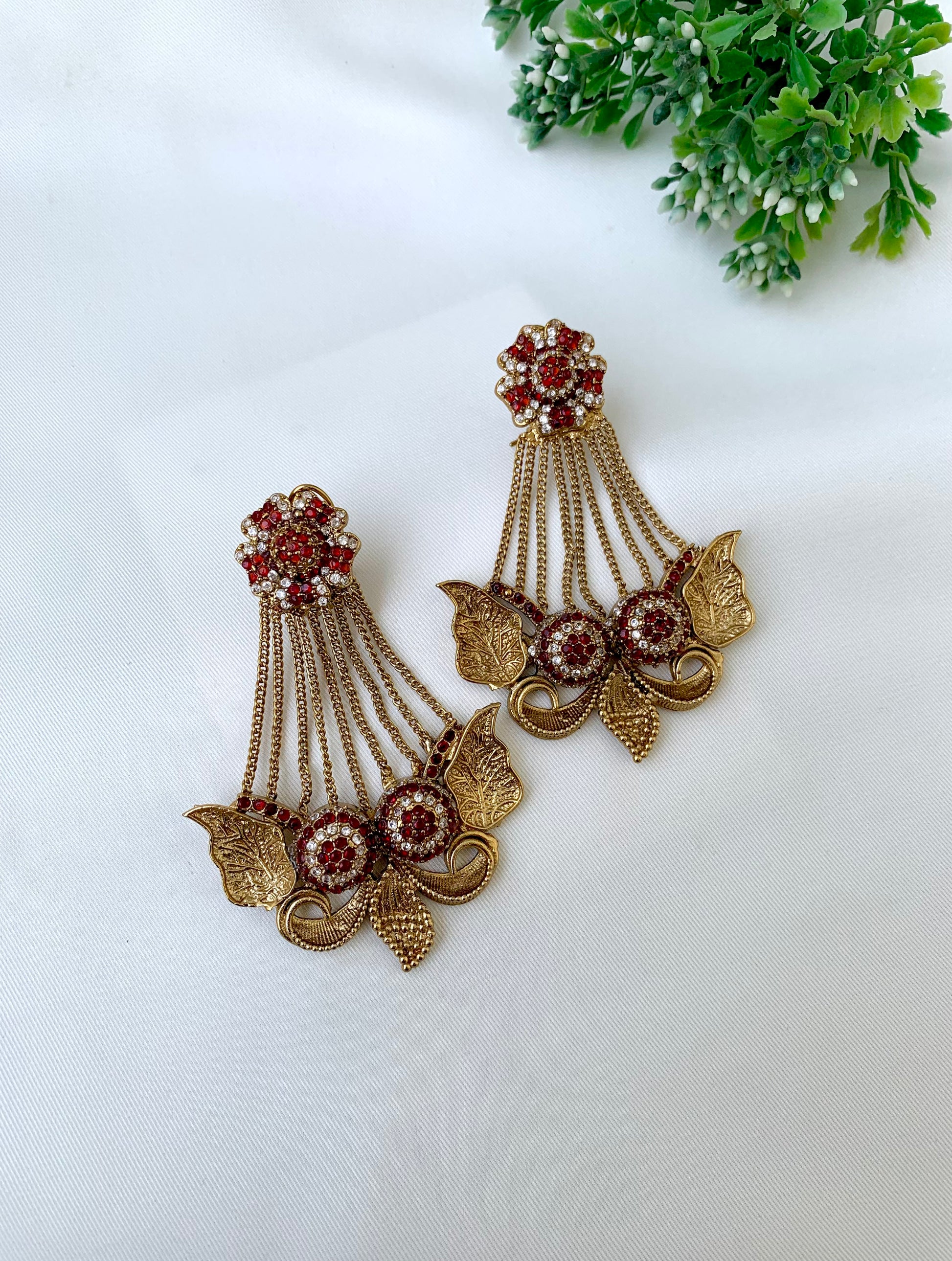 Parvati ruby jhoomar earrings in gold plating with American diamonds and gemstone detailing