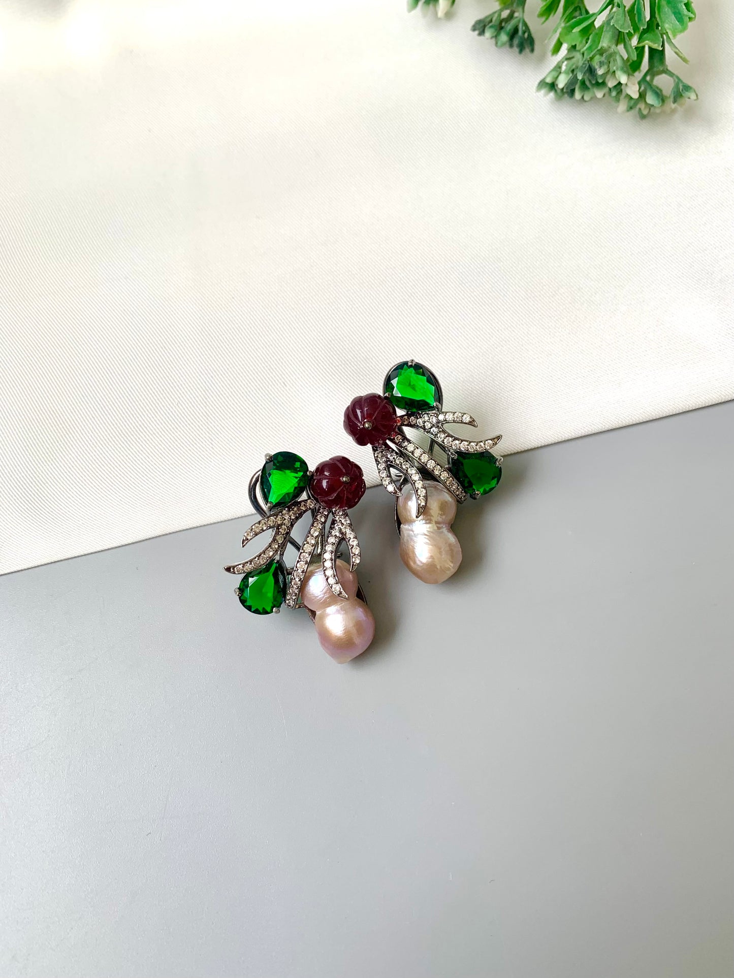Petra emerald baroque pearl studs in rhodium oxidized finish with melon beads and American diamonds