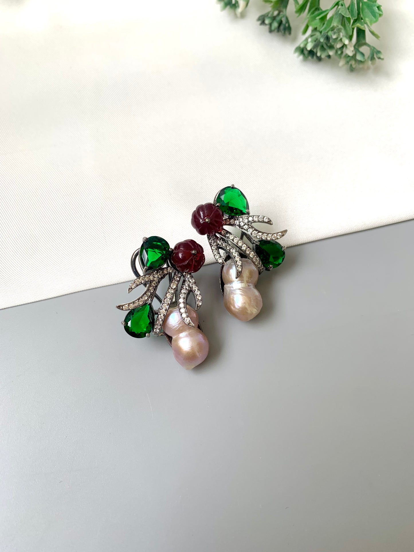 Petra emerald baroque pearl studs in rhodium oxidized finish with melon beads and American diamonds