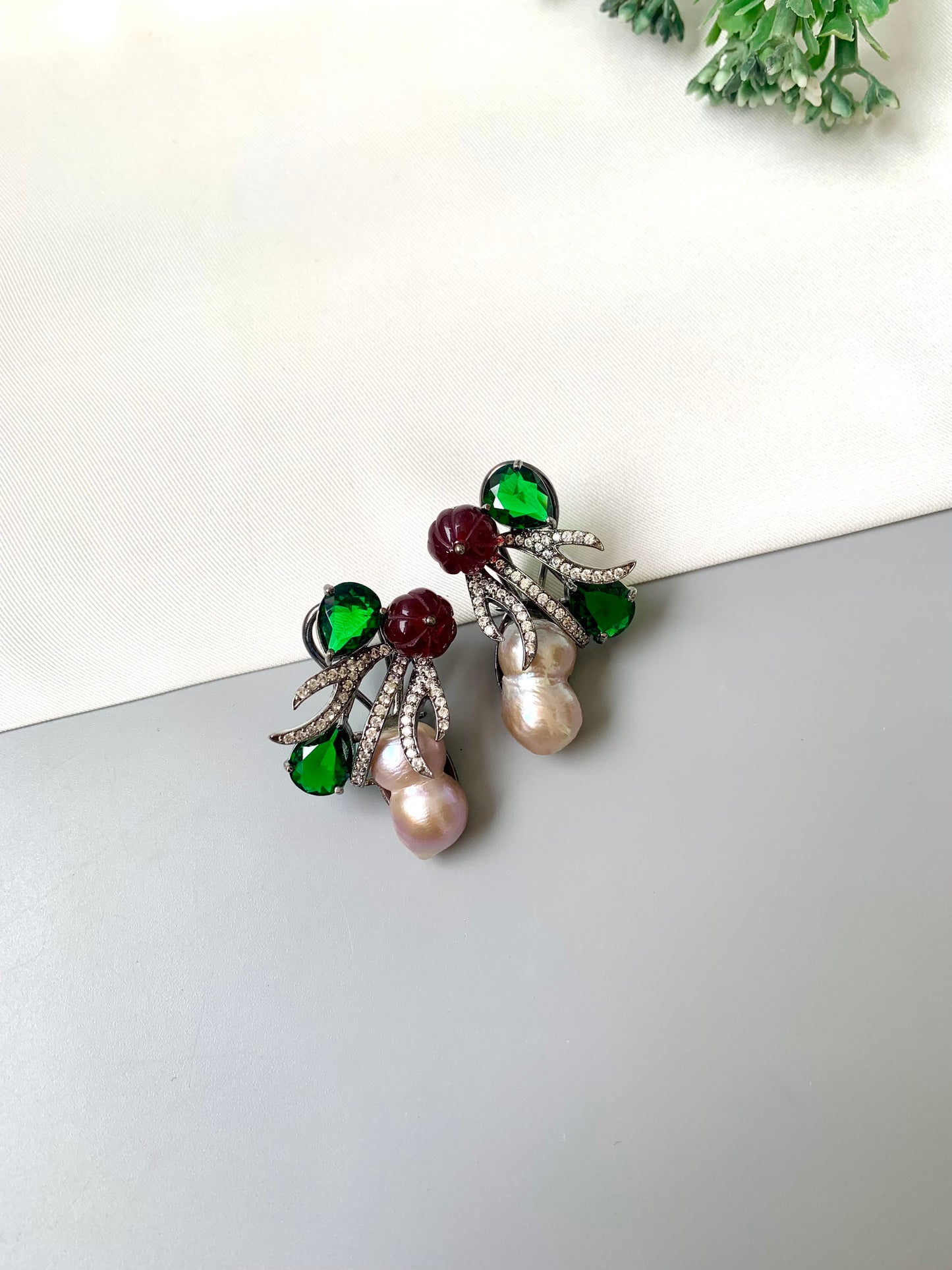 Petra emerald baroque pearl studs in rhodium oxidized finish with melon beads and American diamonds