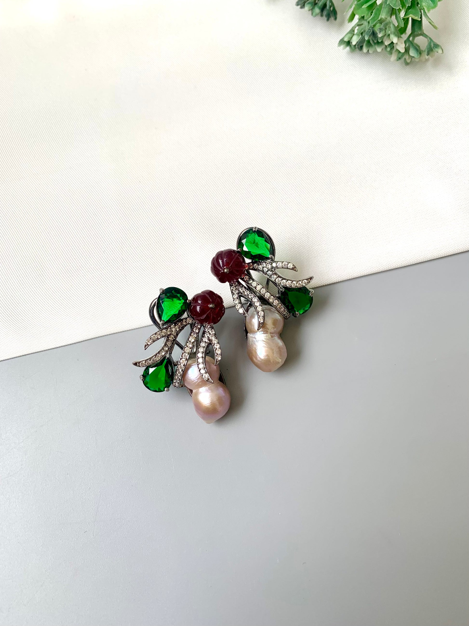 Petra emerald baroque pearl studs in rhodium oxidized finish with melon beads and American diamonds