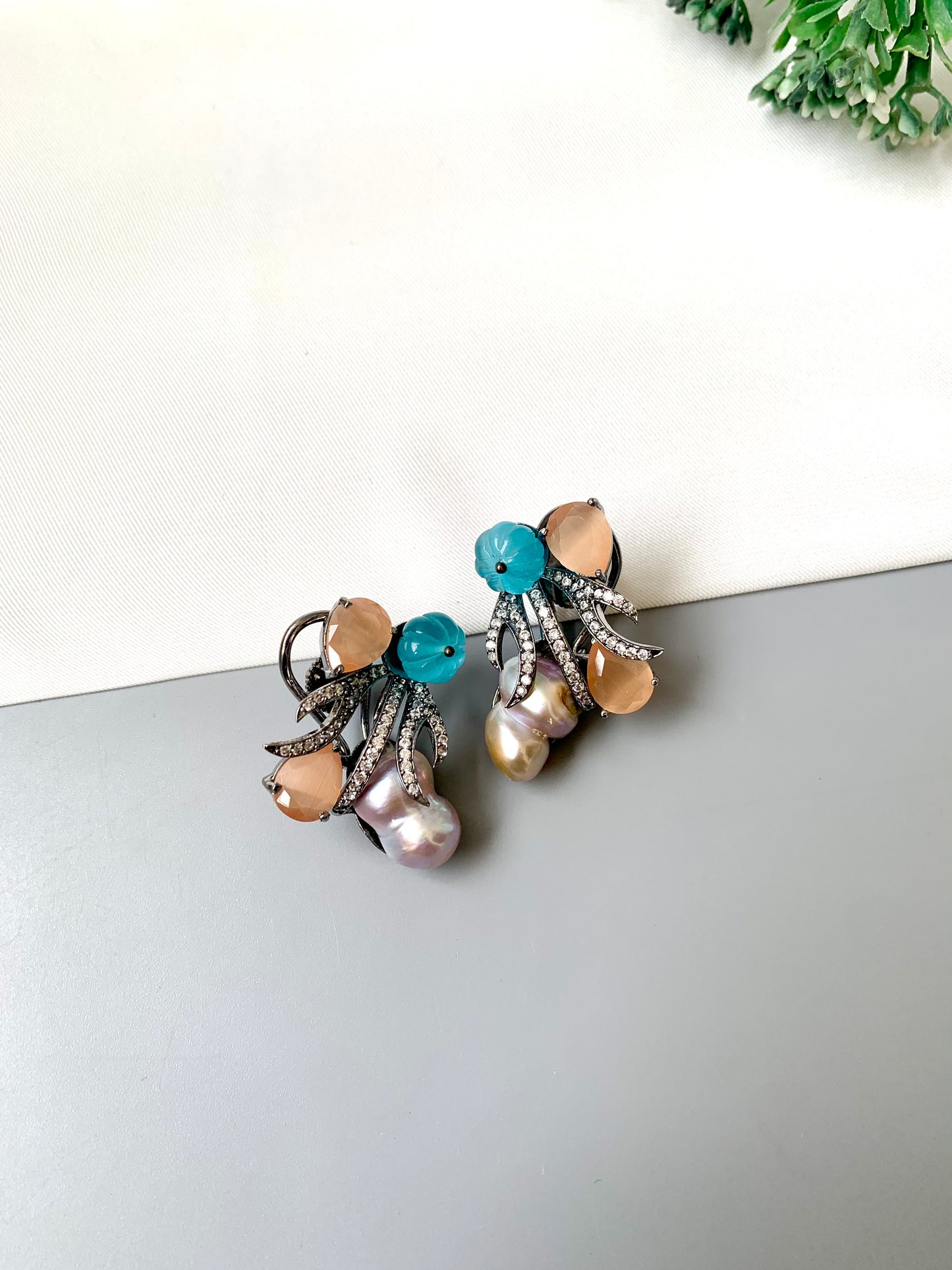 Petra orange onyx baroque pearl studs in rhodium oxidized finish with melon beads and American diamonds