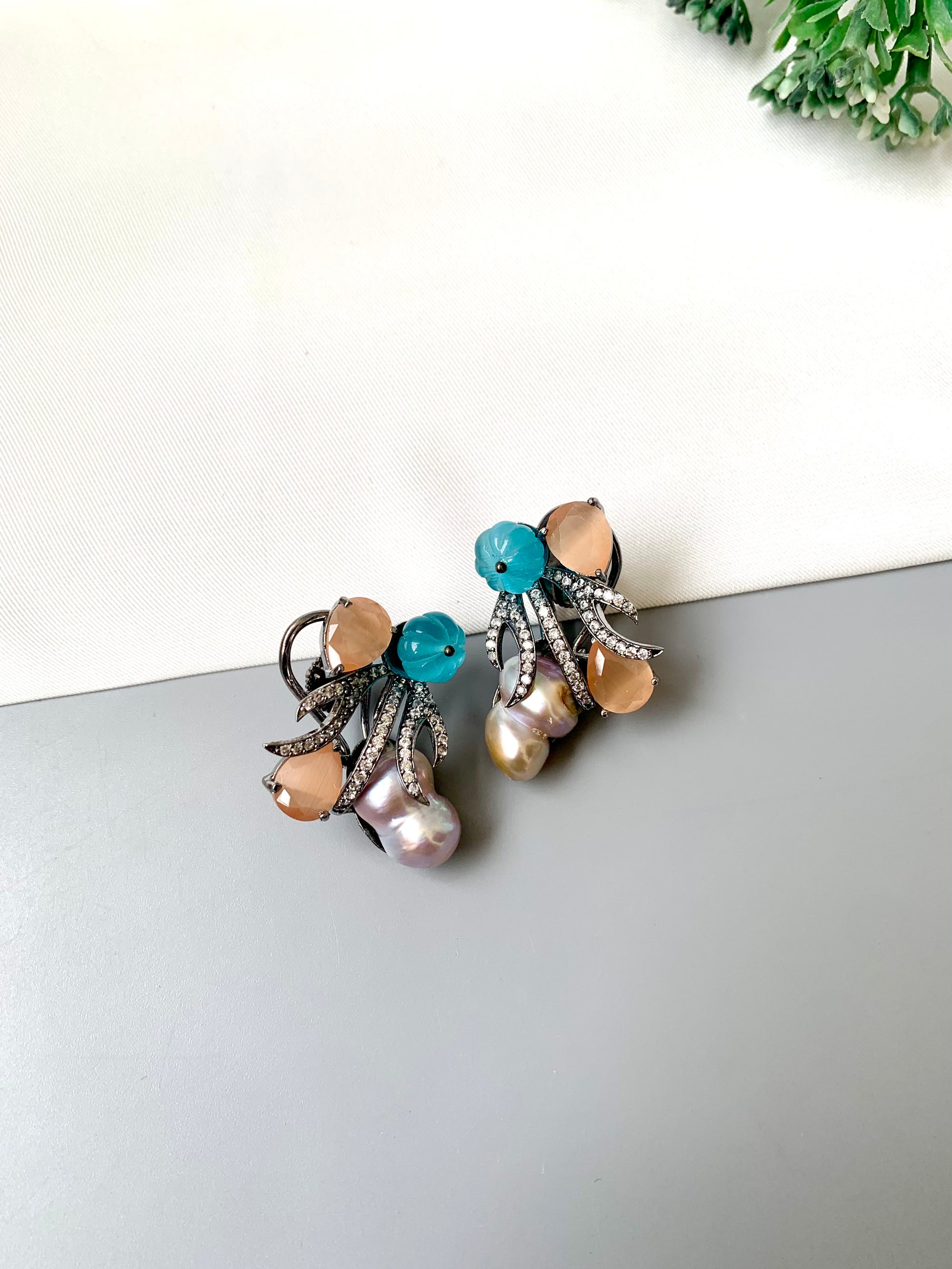 Petra orange onyx baroque pearl studs in rhodium oxidized finish with melon beads and American diamonds